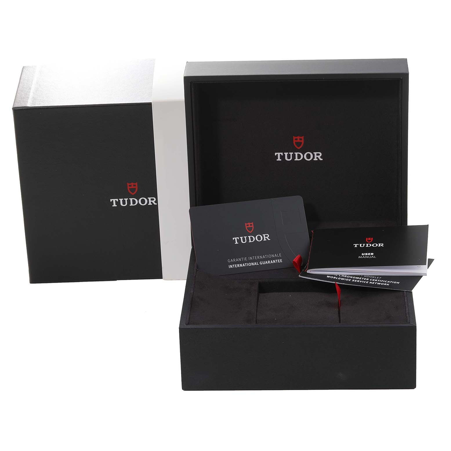 This image shows the open packaging of a Tudor Heritage Black Bay M79470-0003 Men
s Stainless Steel Black Dial M79470-0003 Men
s Stainless Steel Black Dial watch, including the box, guarantee card, and user manual.