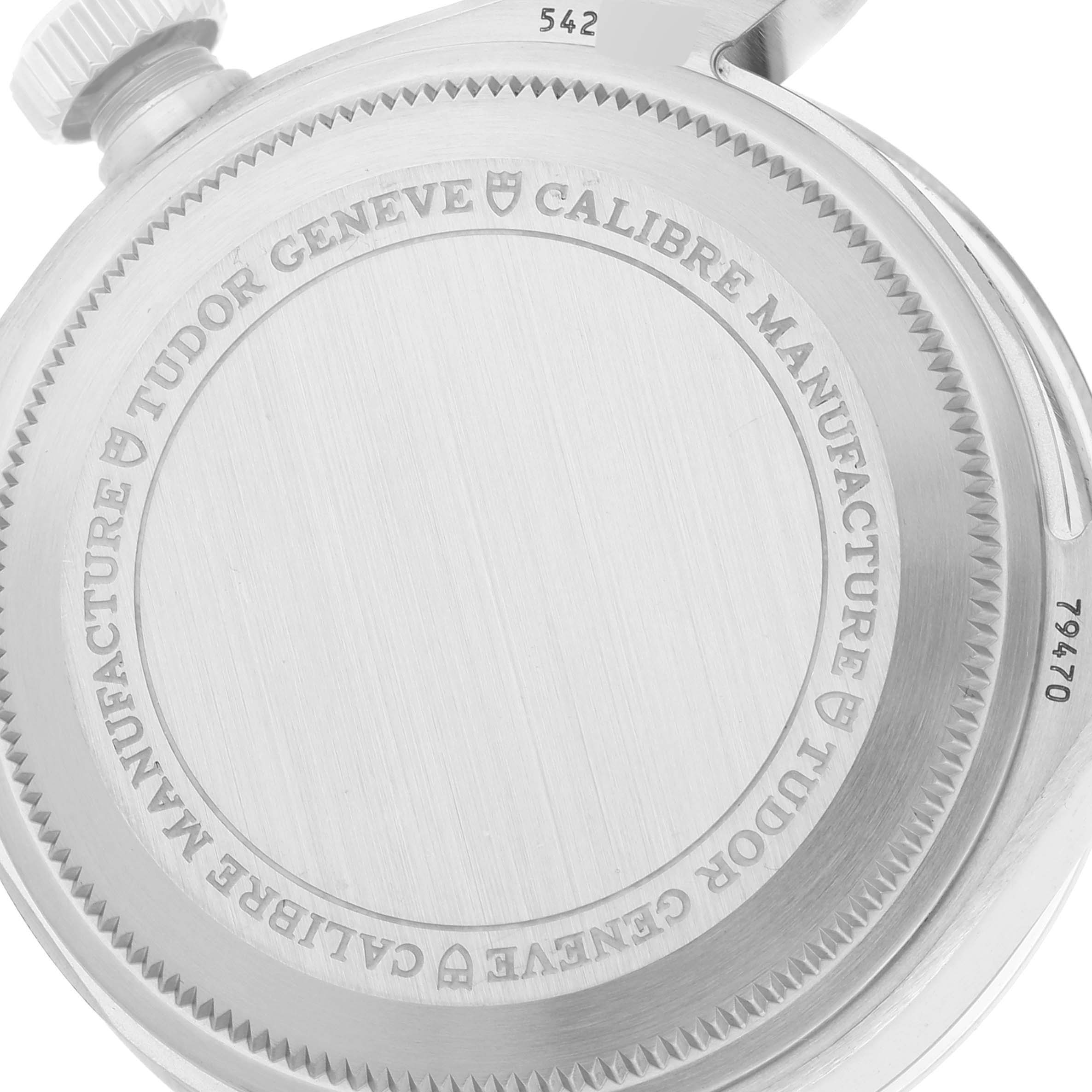 The image shows the backside of a Tudor Heritage Black Bay M79470-0003 Men
s Stainless Steel Black Dial M79470-0003 Men
s Stainless Steel Black Dial watch, highlighting the engraved case back and winding crown.