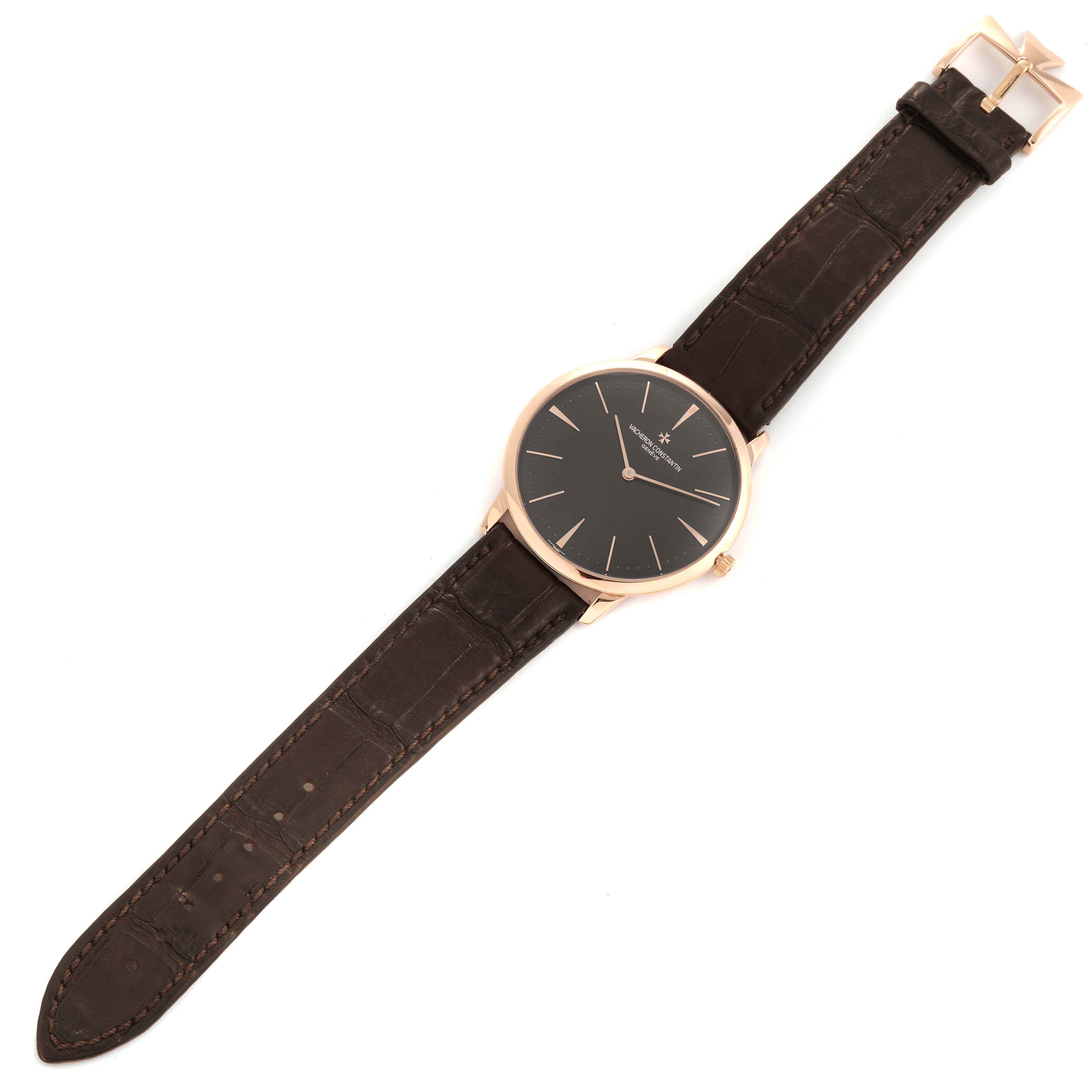 The Patrimony by Vacheron Constantin is shown from a top-down angle, displaying the watch face, case, and leather strap.
