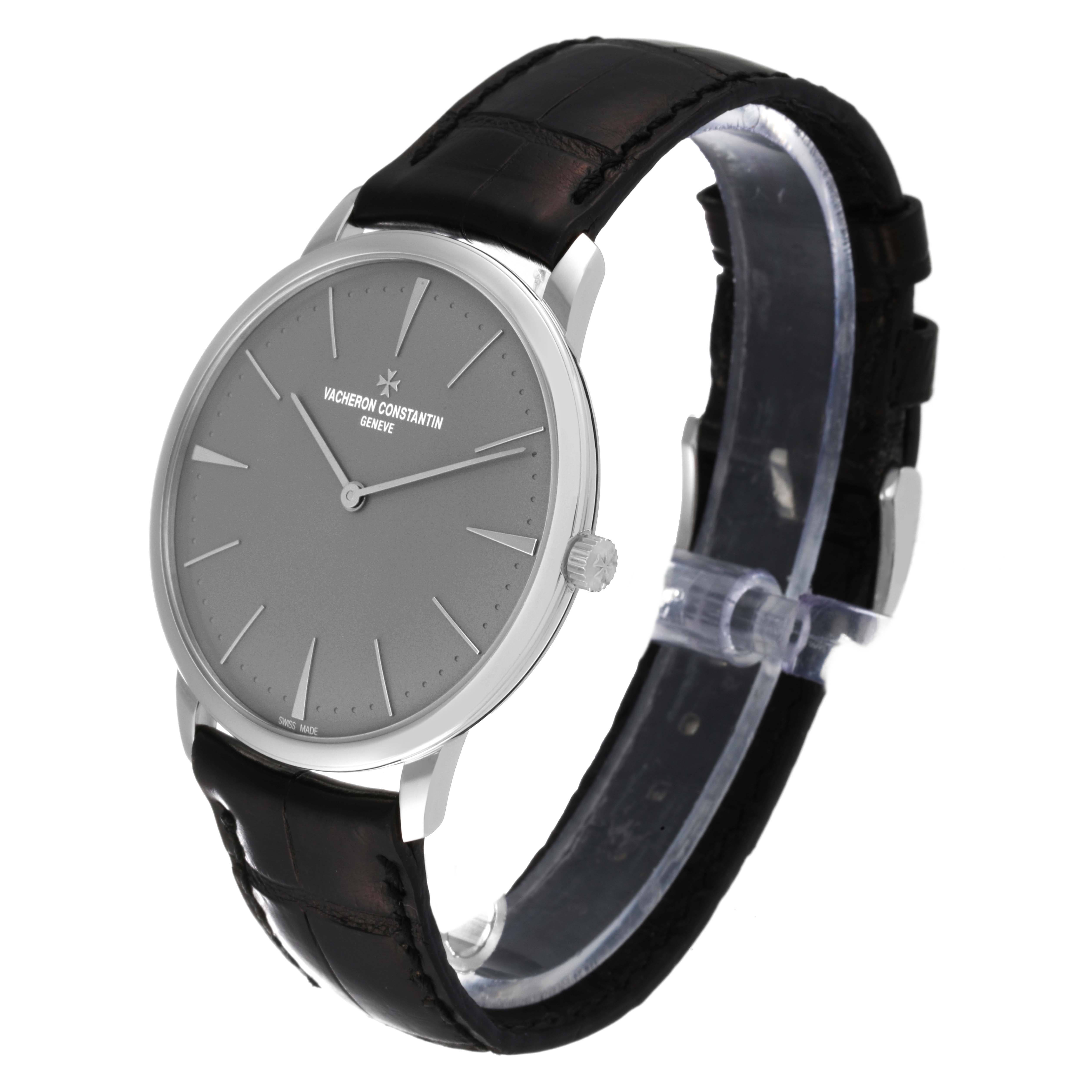 The Vacheron Constantin Patrimony 81180 Men's Platinum Grey Dial 81180 Men's Platinum Grey Dial watch is shown at a 3/4 angle, highlighting its face, crown, and black strap.