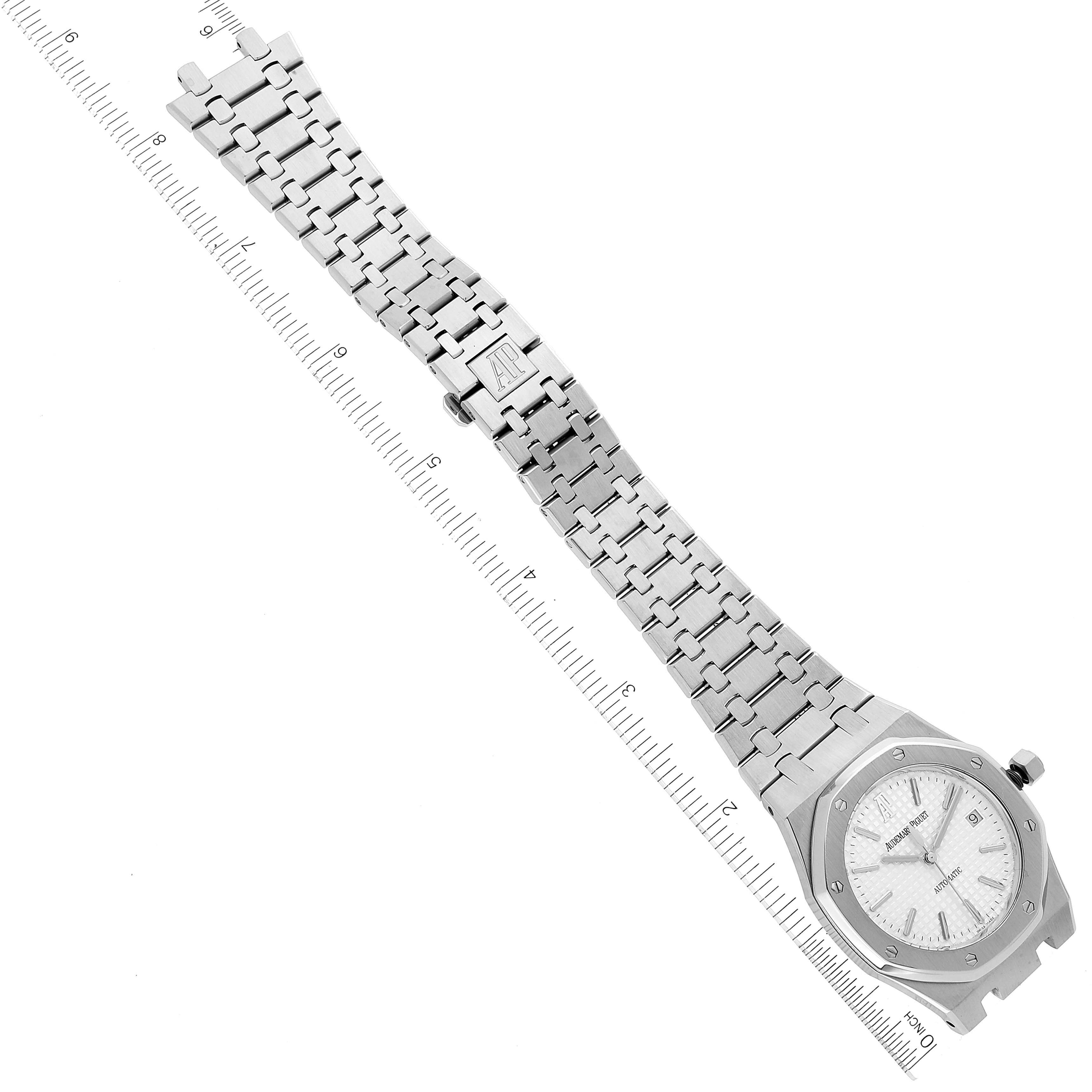 The image shows the entire face and bracelet of the Audemars Piguet Royal Oak 15300ST.00.1220ST.01 Men's Stainless Steel Silver Dial 15300ST.00.1220ST.01 Men's Stainless Steel Silver Dial watch laid flat next to a ruler for scale.