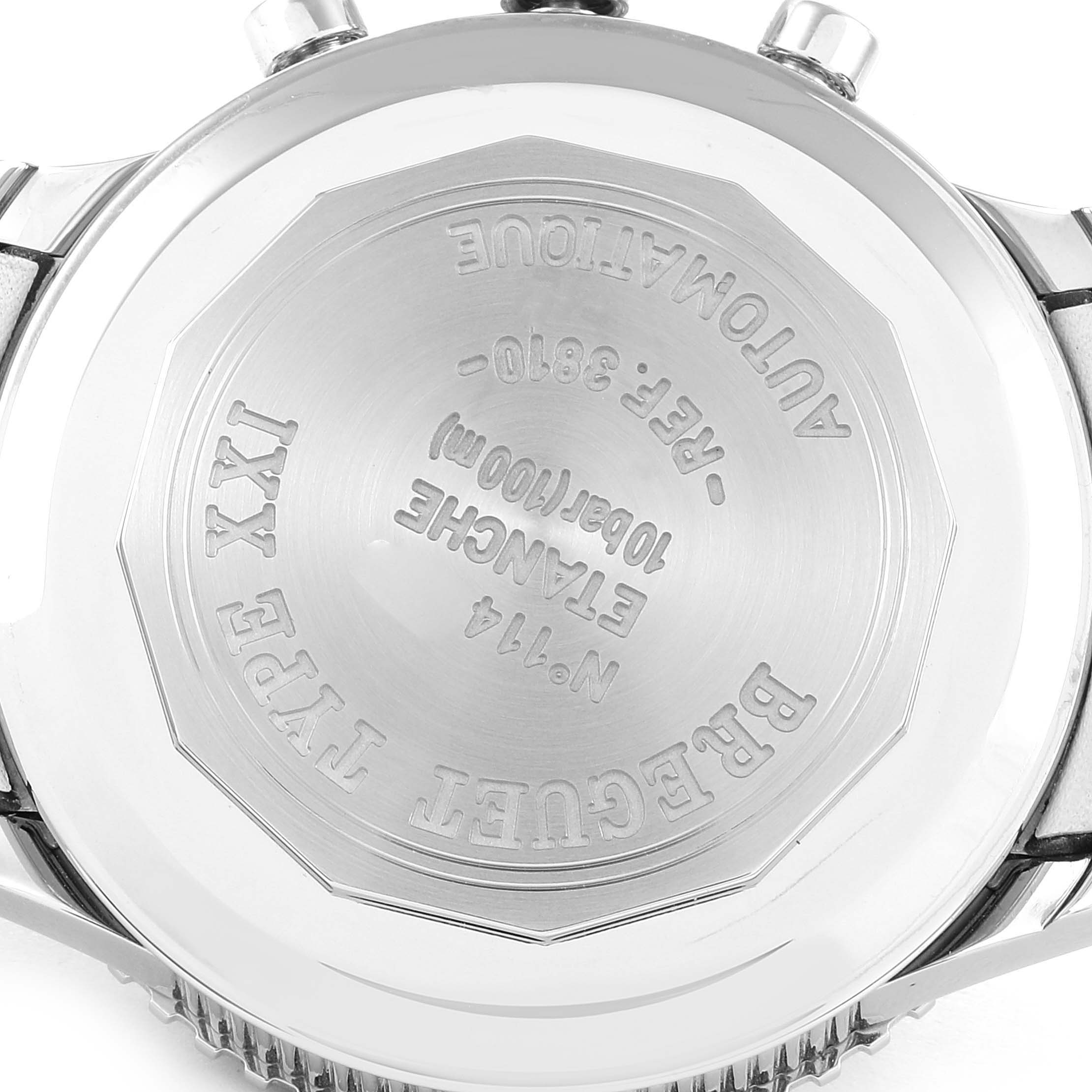 The image shows the back case of a Breguet Type XXI watch, showcasing its engravings and metal finish.