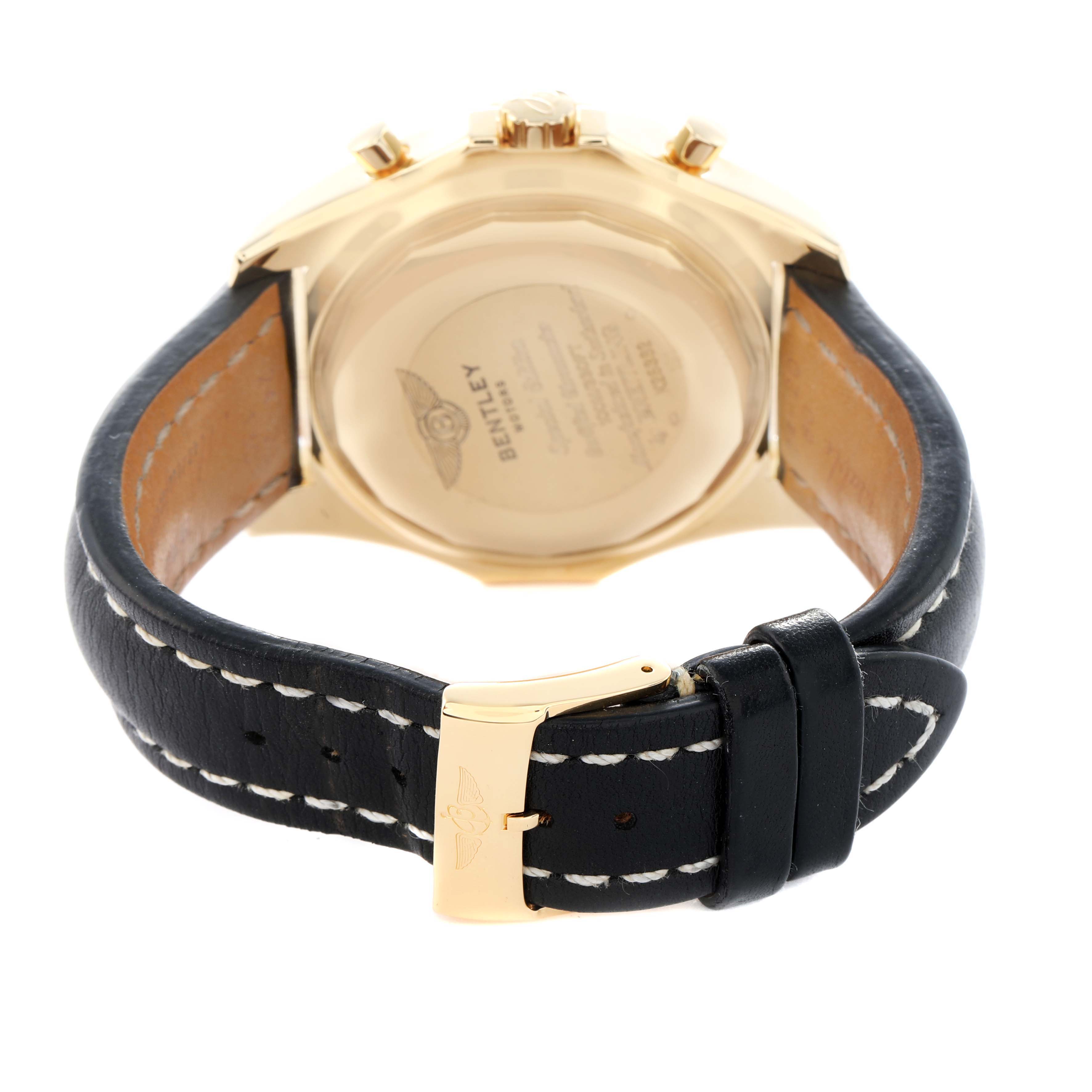 The image shows the back of the Breitling Bentley K25362 Men's Yellow Gold White Dial watch, highlighting the case back, strap, and clasp.