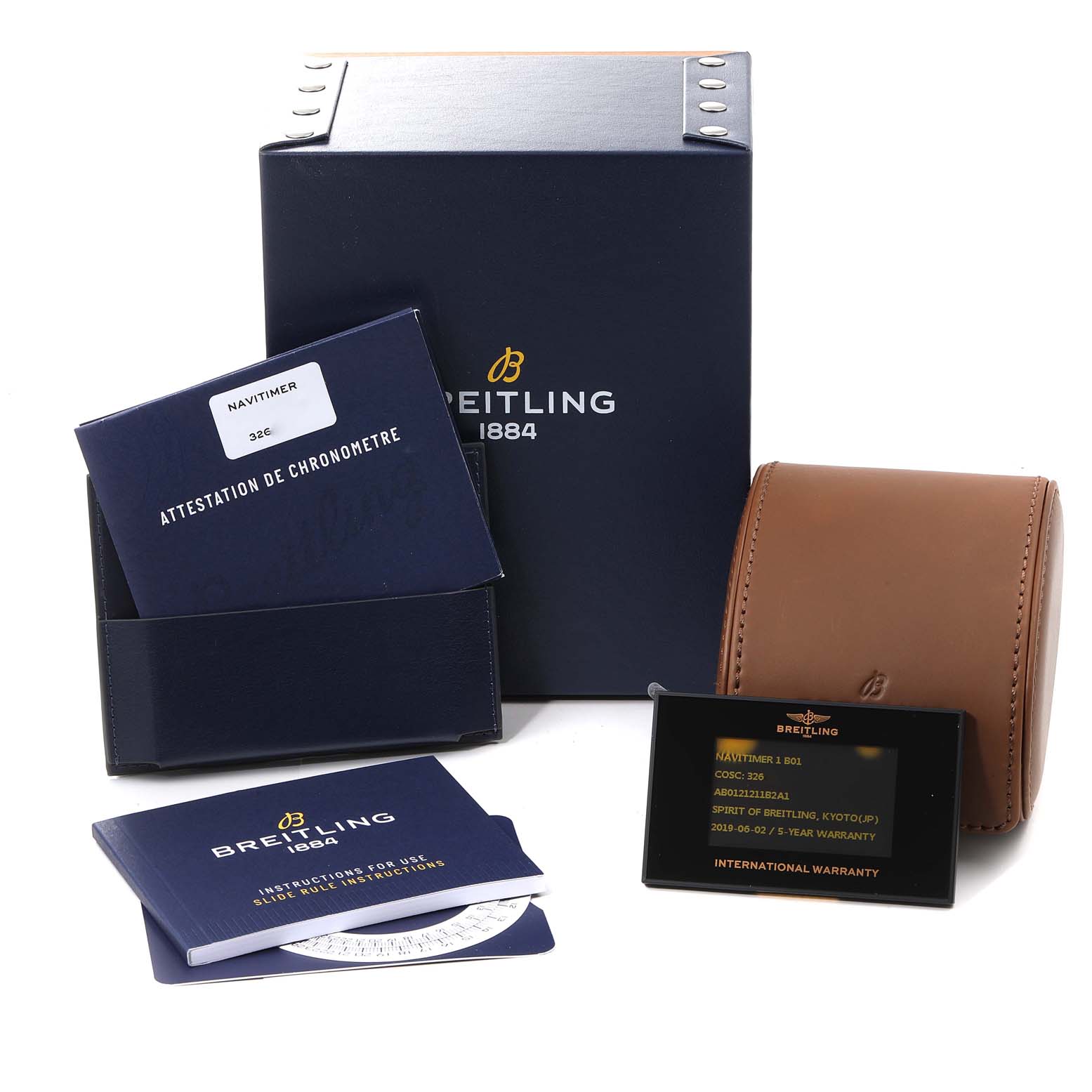 The image shows Breitling Navitimer AB0121 Men
s Stainless Steel Black Dial AB0121 Men
s Stainless Steel Black Dial accessories: a box, instruction manual, chronometer certificate, warranty card, and a leather watch case.