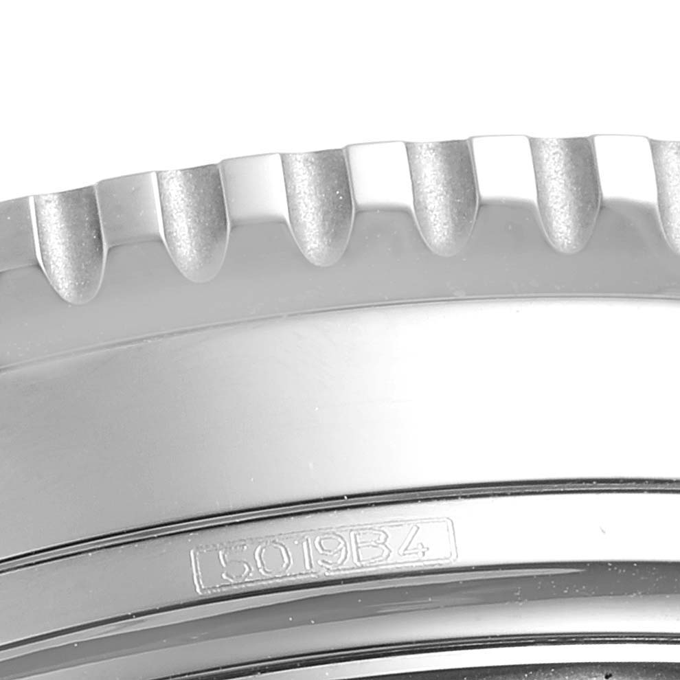 The image shows a close-up of the bezel and part of the case of a Breitling Navitimer A13324 Men
s Stainless Steel Black Dial A13324 Men
s Stainless Steel Black Dial watch, highlighting its serial number and engraved details.
