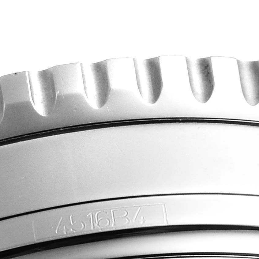 This image shows a close-up of the bezel and part of the case of a Navitimer model watch by Breitling.