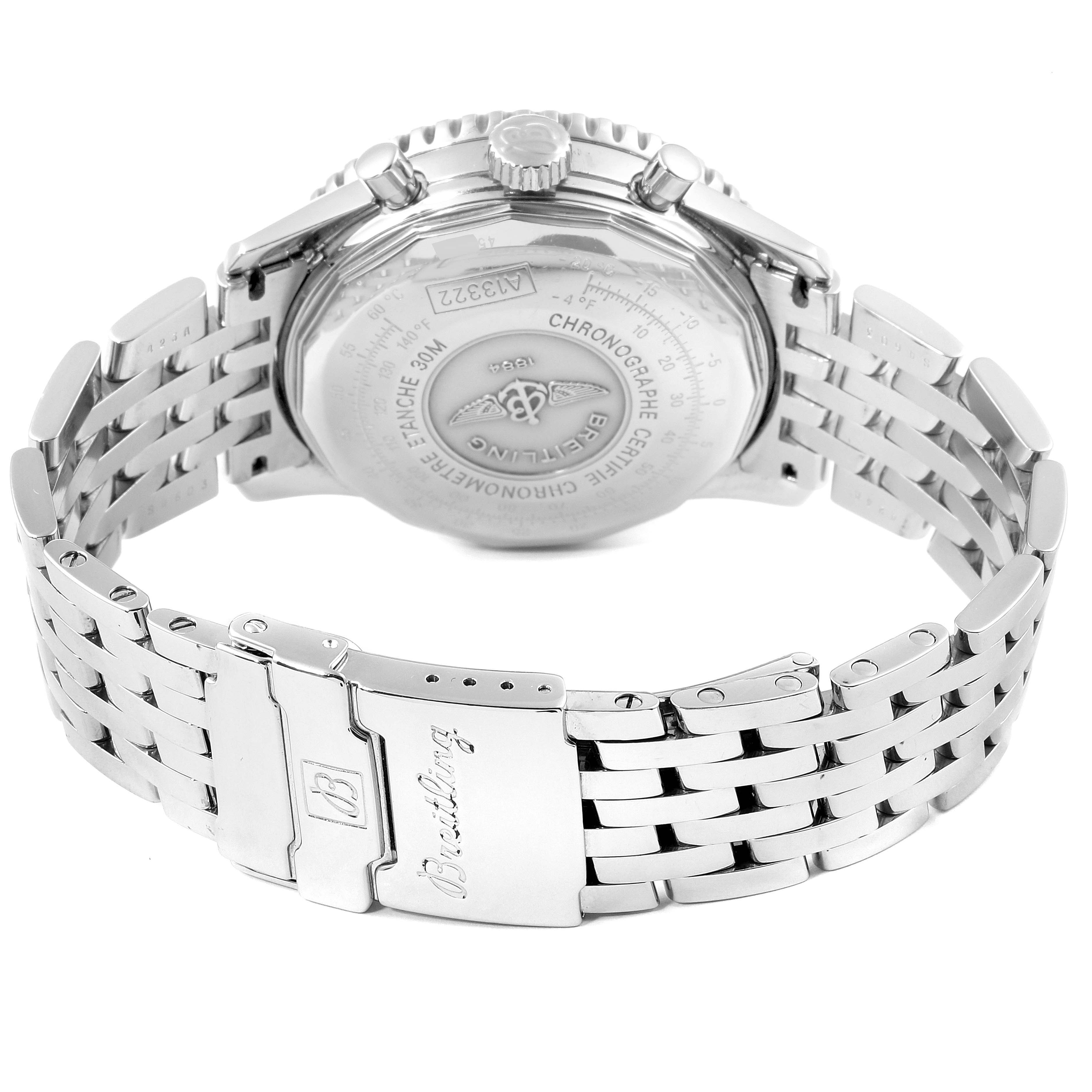 The image shows the back and clasp of a Navitimer model by Breitling, highlighting the case back and metal bracelet.