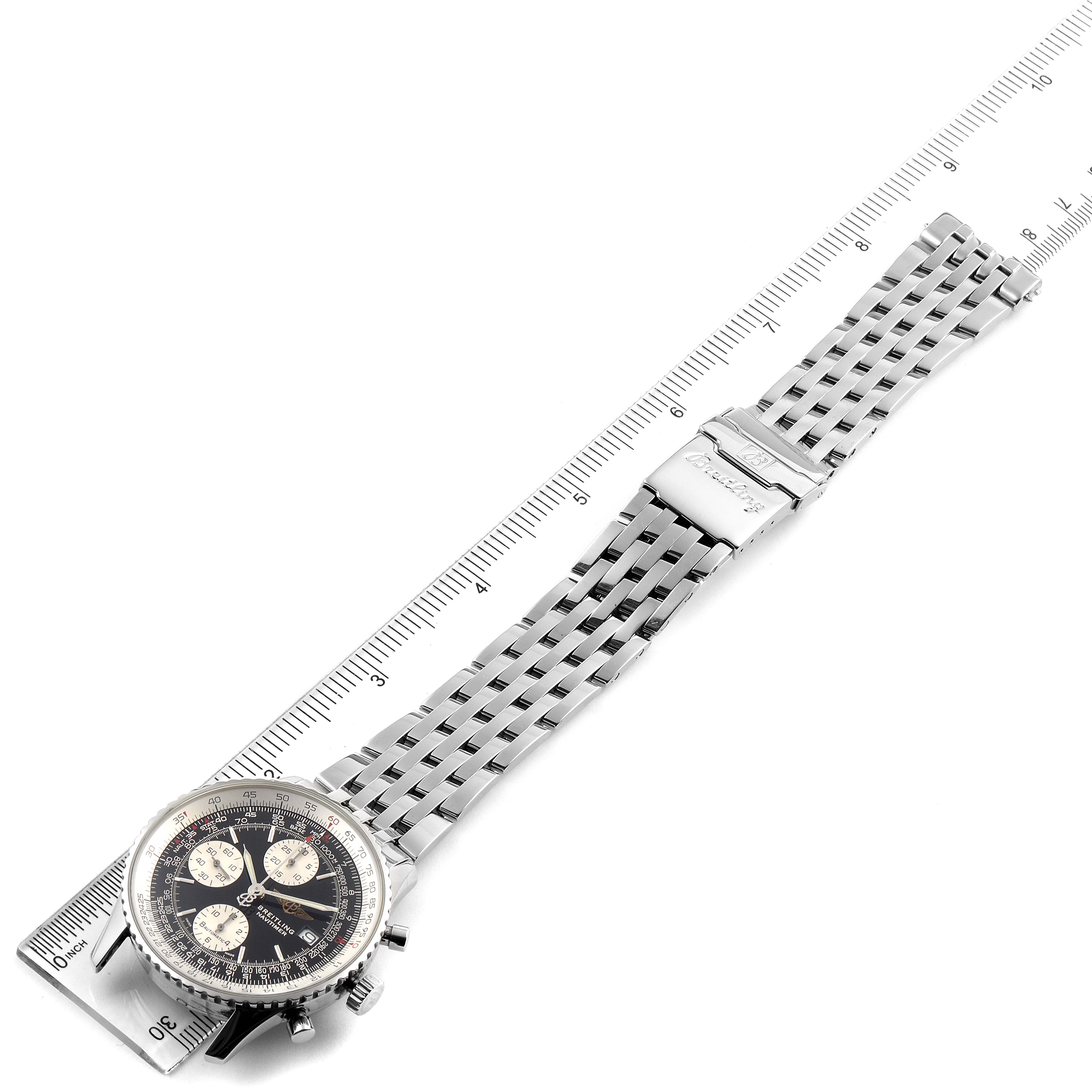 The image shows a top-down view of the Breitling Navitimer A13322 Men's Stainless Steel Black Dial A13322 Men's Stainless Steel Black Dial watch, including its face, bracelet, and clasp, alongside a ruler for scale.