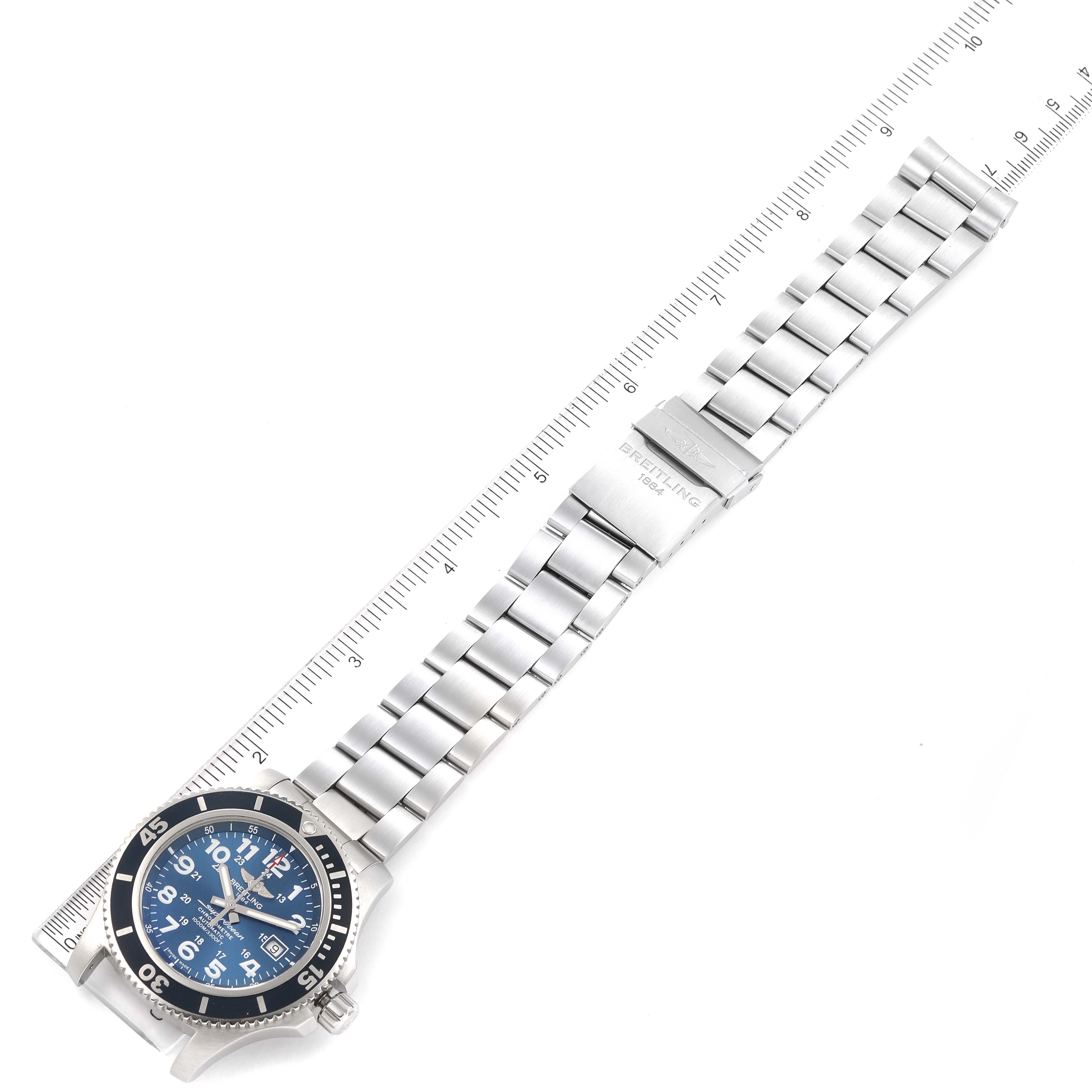 The image shows a top-down view of a Breitling Superocean A17392D8/C910 Men's Stainless Steel Blue Dial A17392D8/C910 Men's Stainless Steel Blue Dial watch, highlighting the entire bracelet and the face with a ruler for reference.