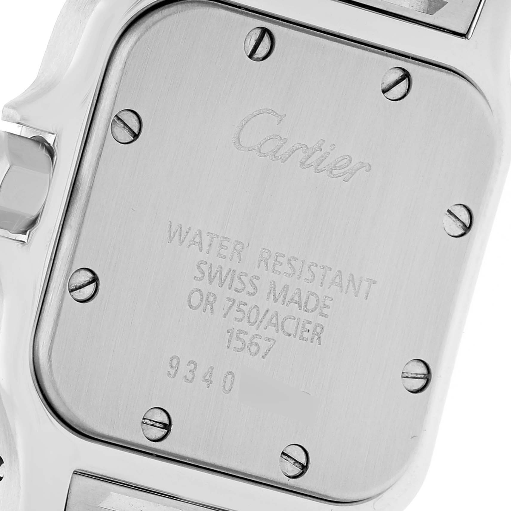 This image shows the back case of a Santos model by Cartier, displaying engraved details.