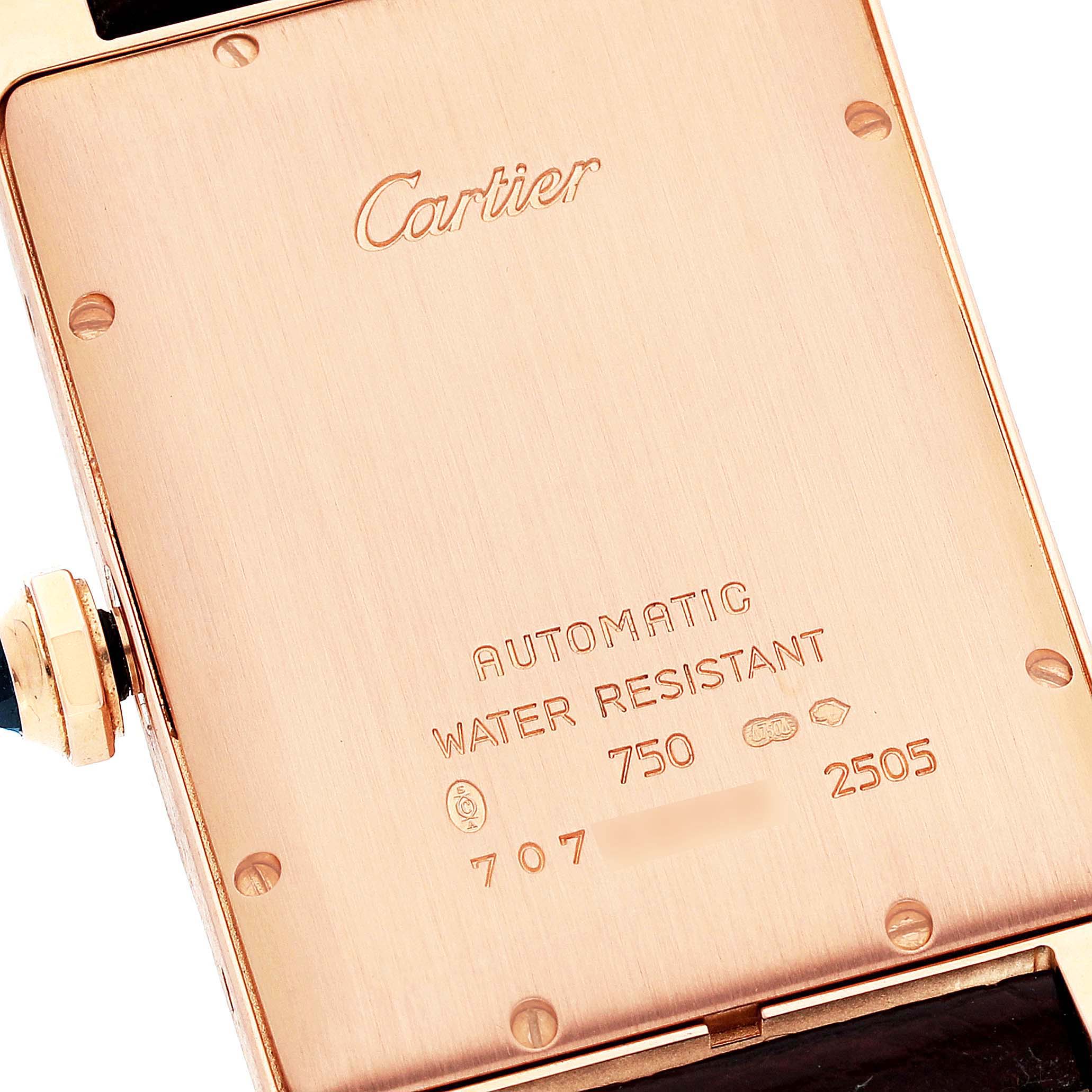 The image shows the backside of a Tank Américaine watch by Cartier, displaying the brand name, specifications, and serial number.