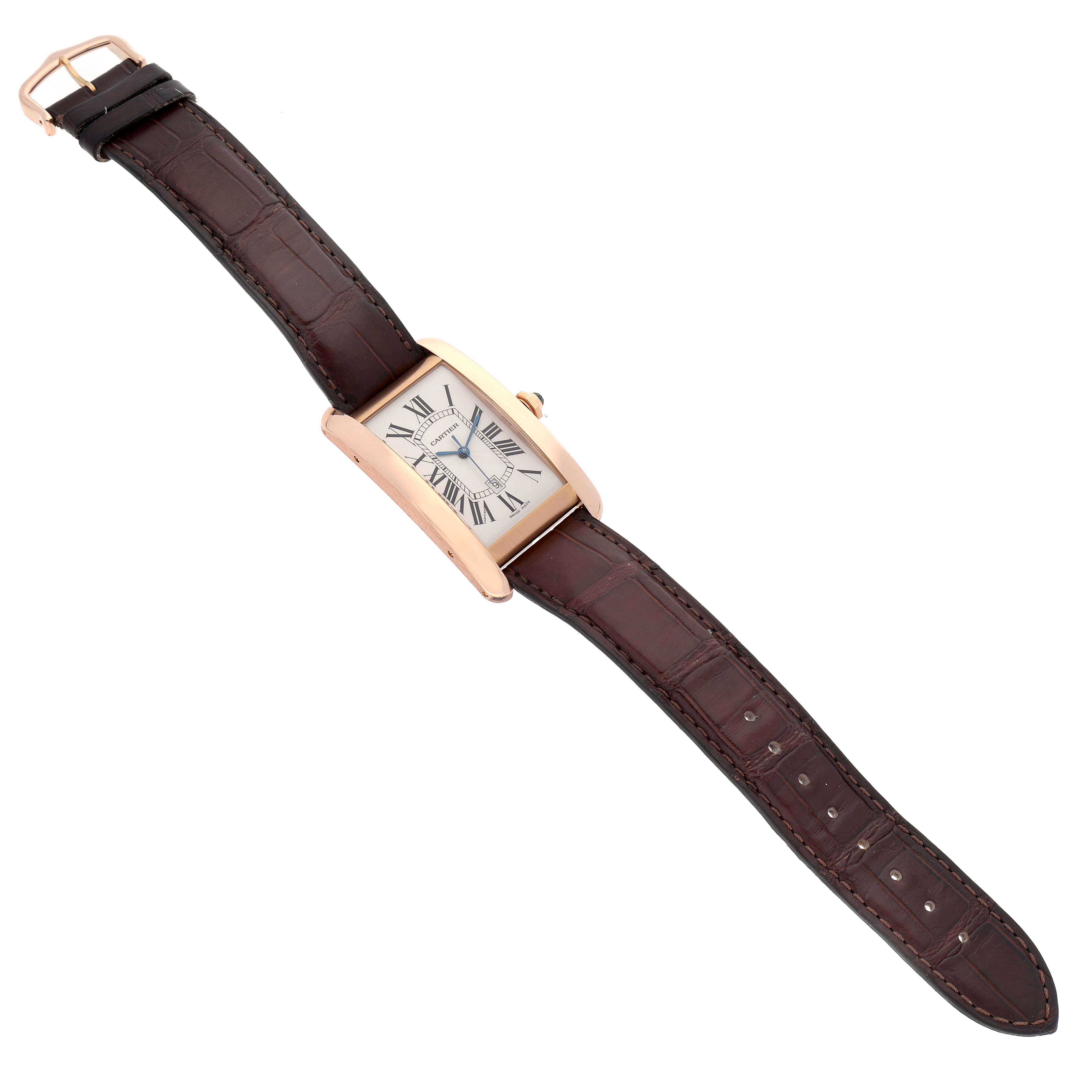This image shows the Cartier Tank Americaine W2609156 Men's Rose Gold Silver Dial W2609156 Men's Rose Gold Silver Dial watch laid flat, displaying its rectangular face and both ends of the brown leather strap.