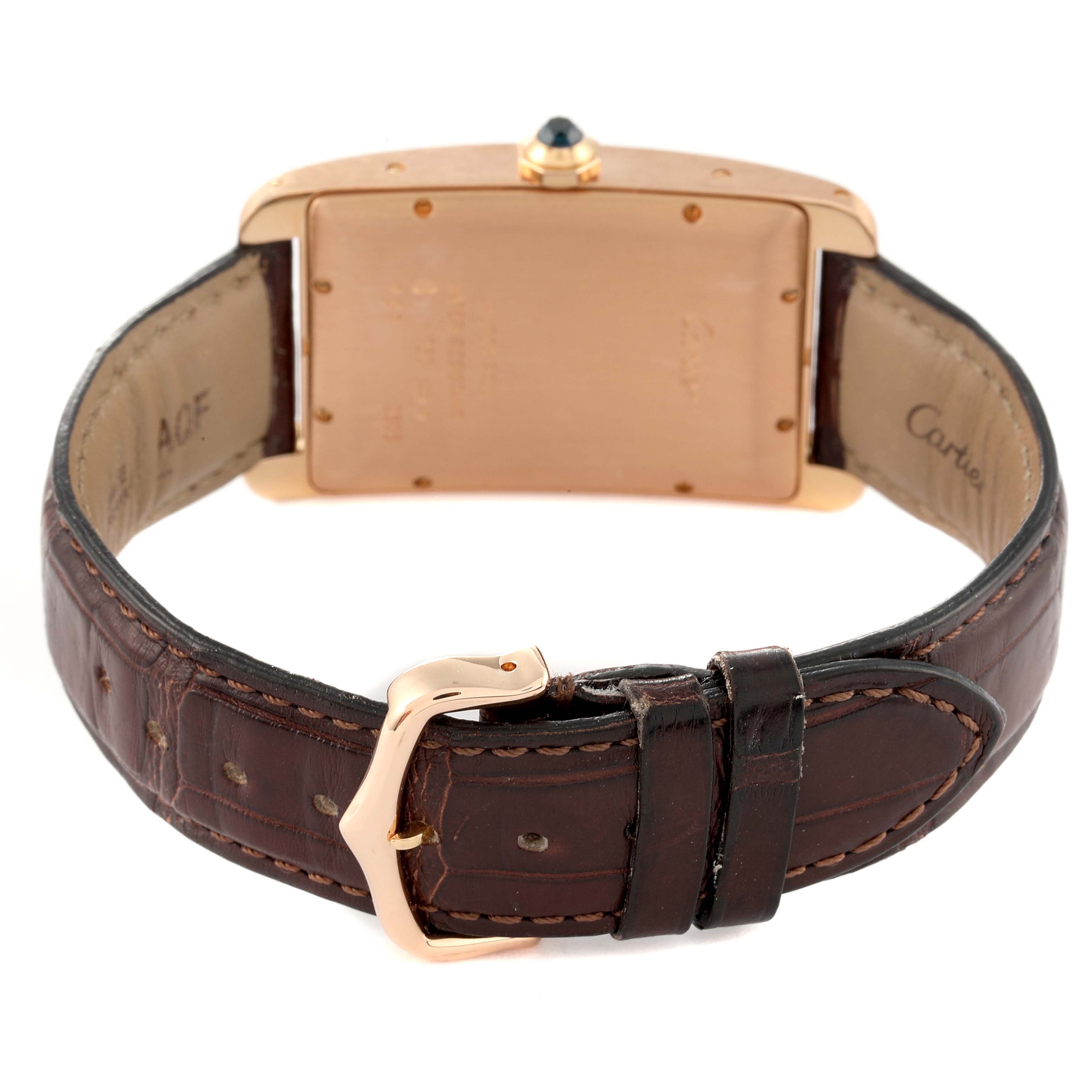 The image shows the back view of a Cartier Tank Americaine W2609156 Men's Rose Gold Silver Dial W2609156 Men's Rose Gold Silver Dial watch, highlighting the leather strap and the deployment clasp.