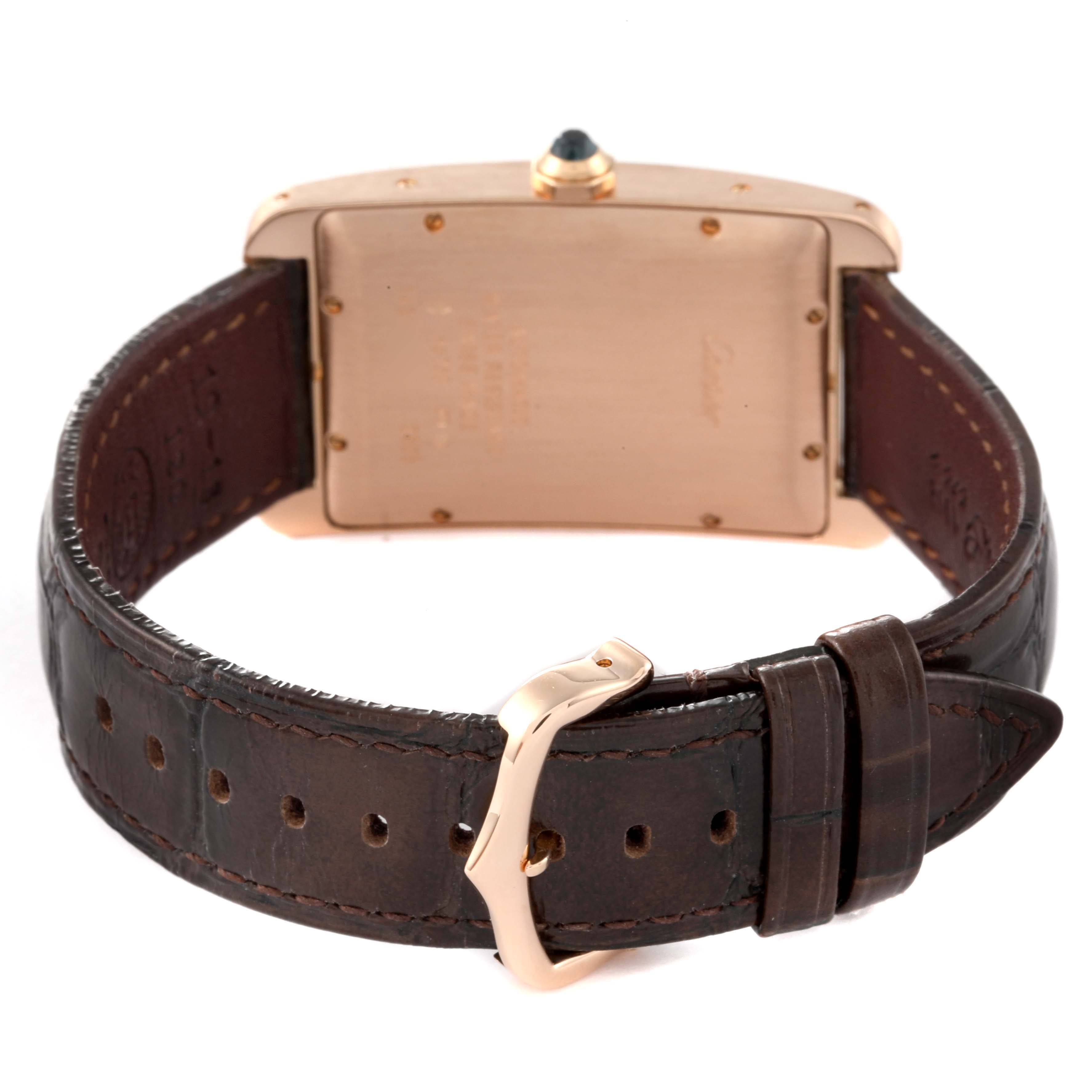 This image shows the back view of the Cartier Tank Americaine W2609156 Men
s Rose Gold Silver Dial W2609156 Men
s Rose Gold Silver Dial watch, highlighting its case, crown, and leather strap with a buckle.