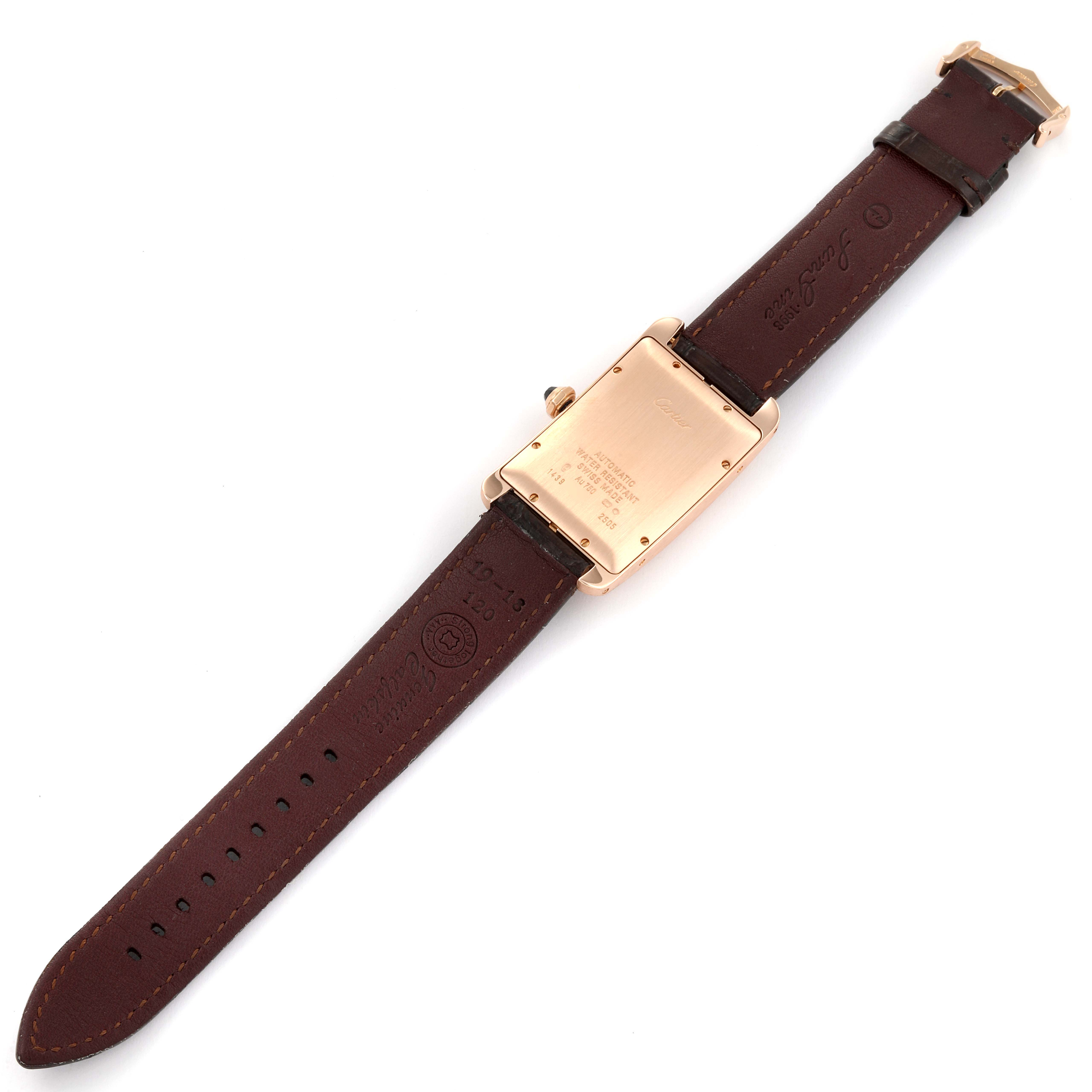 The Cartier Tank Americaine W2609156 Men
s Rose Gold Silver Dial W2609156 Men
s Rose Gold Silver Dial watch is shown from the back, displaying its caseback and leather strap.