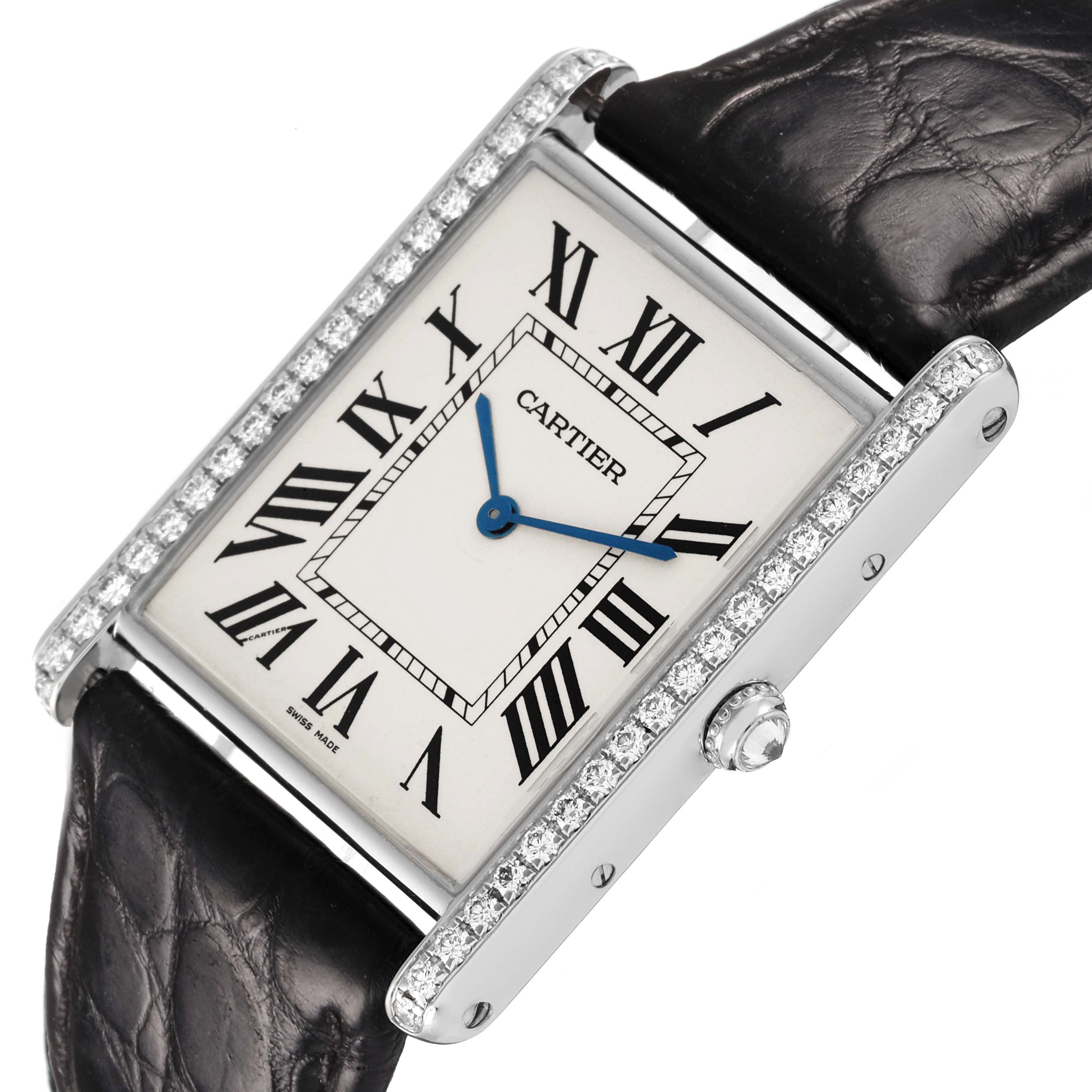 The Cartier Tank Louis WT200006 Men's White Gold Silver Dial watch is shown at a three-quarter angle, revealing the face, crown, diamond accents, and leather strap.