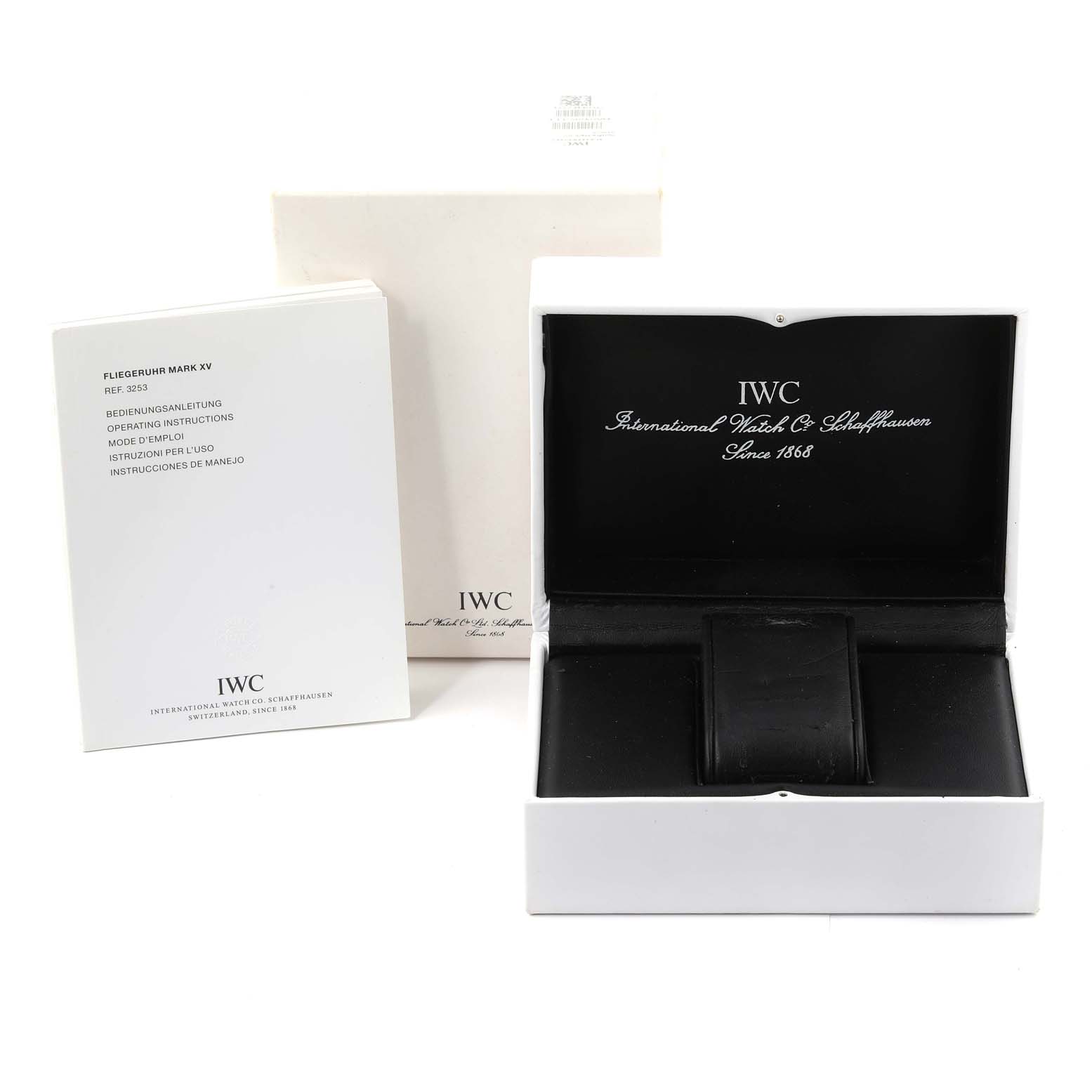 The image shows the open case and instruction manual for an IWC Pilot IW325311 Men's Stainless Steel Black Dial IW325311 Men's Stainless Steel Black Dial model watch from a straight-on angle.