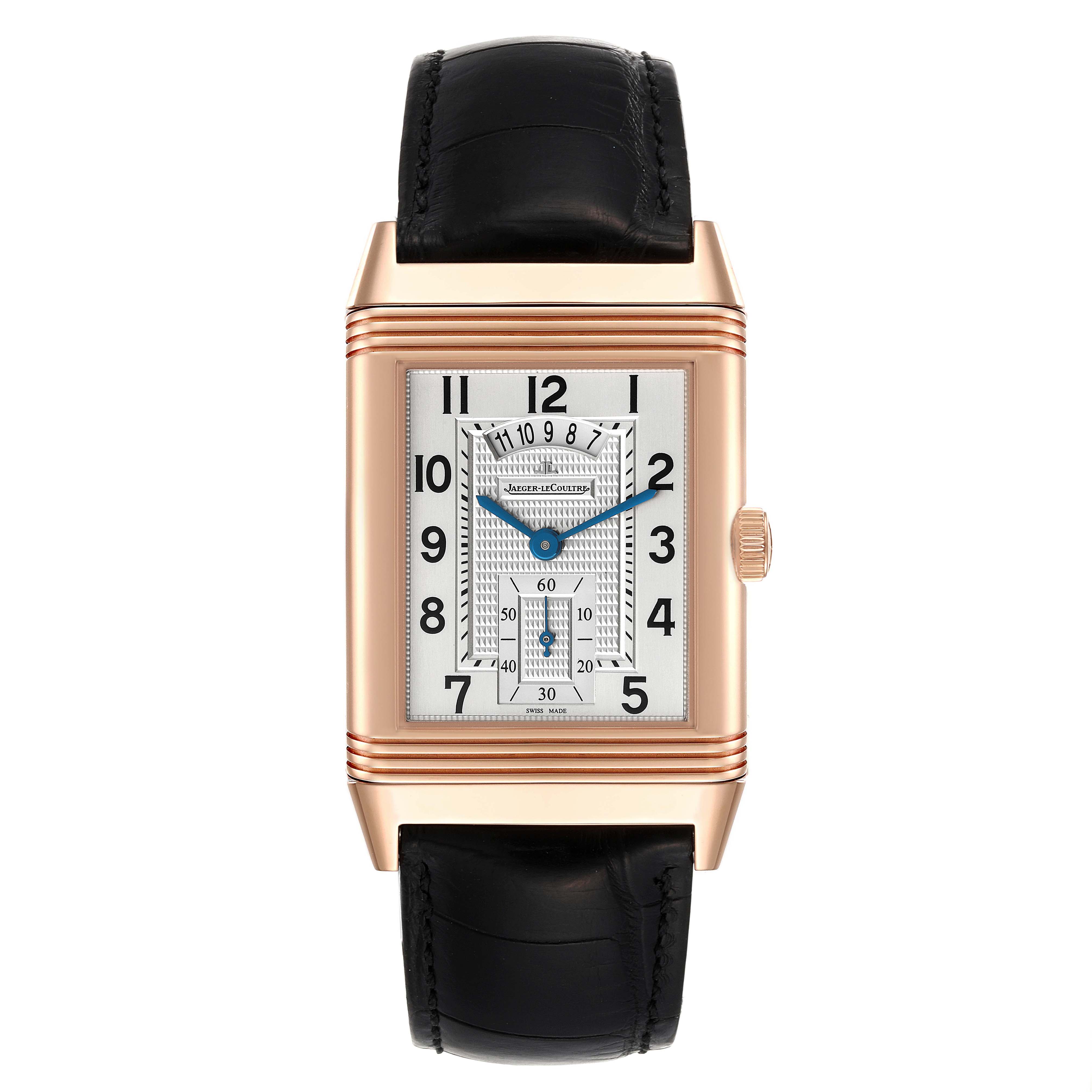 The image shows a Reverso model watch by Jaeger LeCoultre, viewed from the front, featuring its dial, case, and strap.