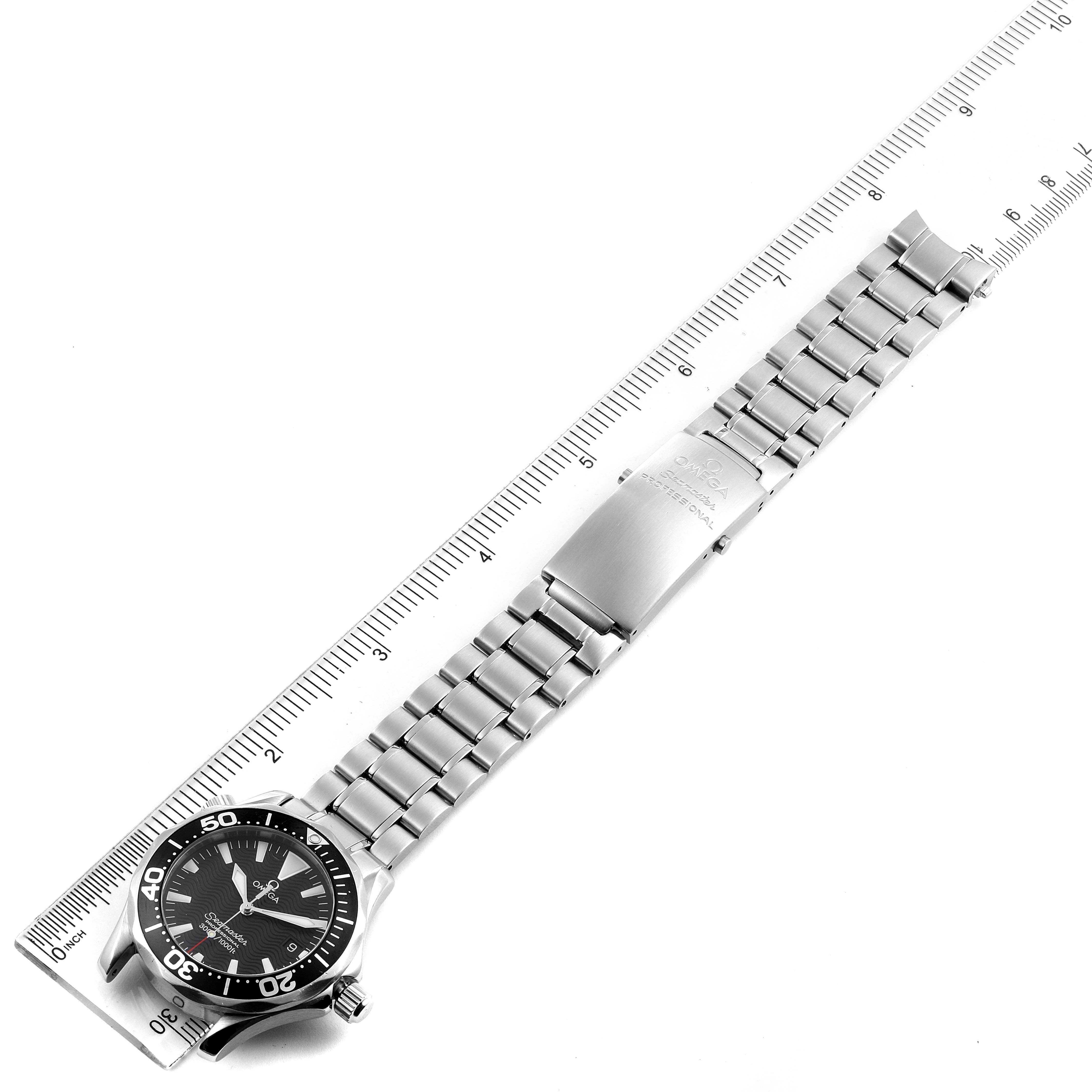 The image shows an Omega Seamaster 2262.50.00 Men
s Stainless Steel Black Dial 2262.50.00 Men
s Stainless Steel Black Dial watch laid flat next to a ruler, showcasing its face and metal bracelet.