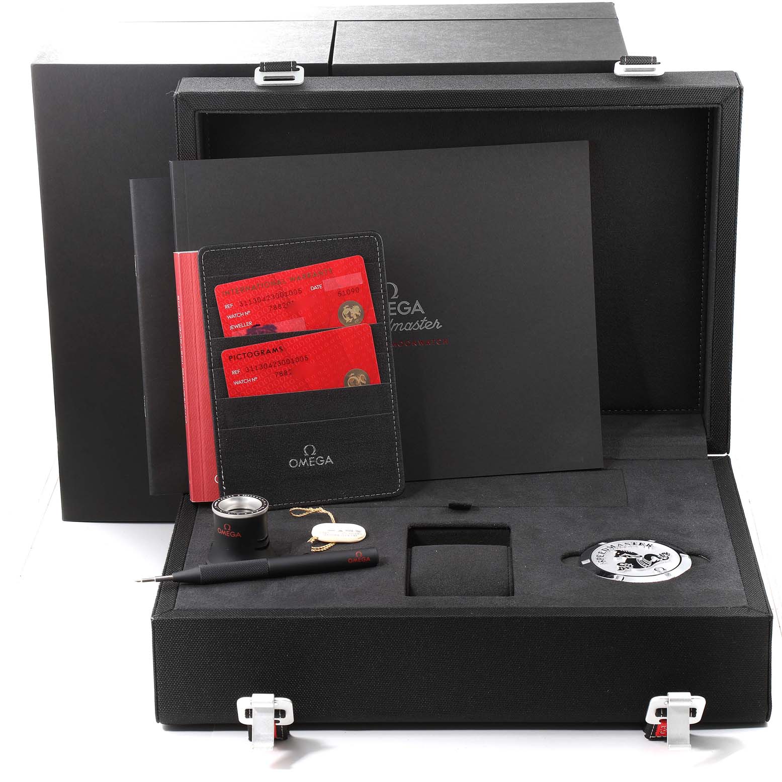 This Omega Speedmaster 311.30.42.30.01.005 Men's Stainless Steel Black Dial 311.30.42.30.01.005 Men's Stainless Steel Black Dial watch box includes cards, a loupe, a tool, a coaster, and document holders, all displayed in an open black case.