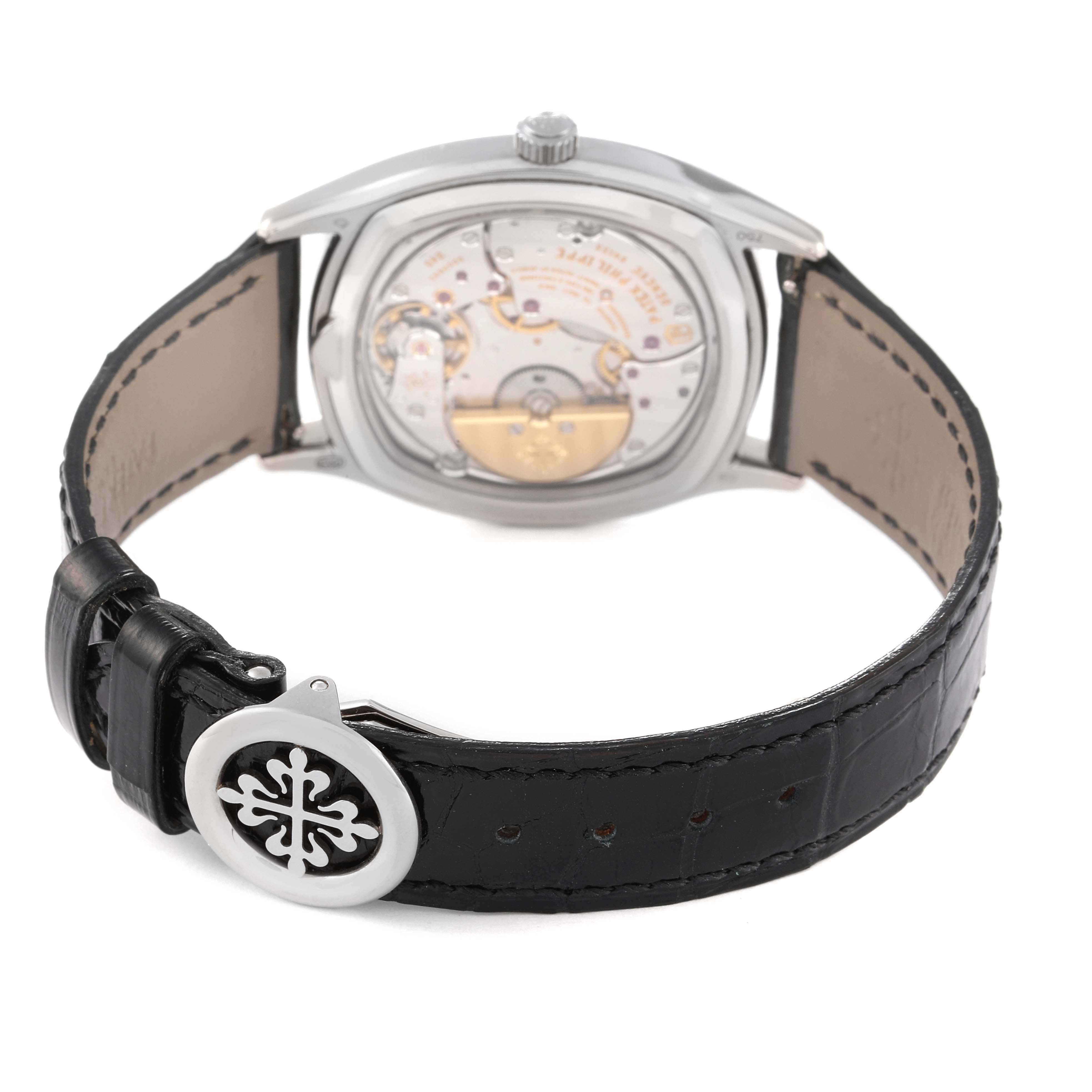 The image shows the back view of a Patek Philippe Complications 5940G - 001 Men's White Gold Silver Dial 5940G - 001 Men's White Gold Silver Dial model, highlighting its movement and black leather strap.