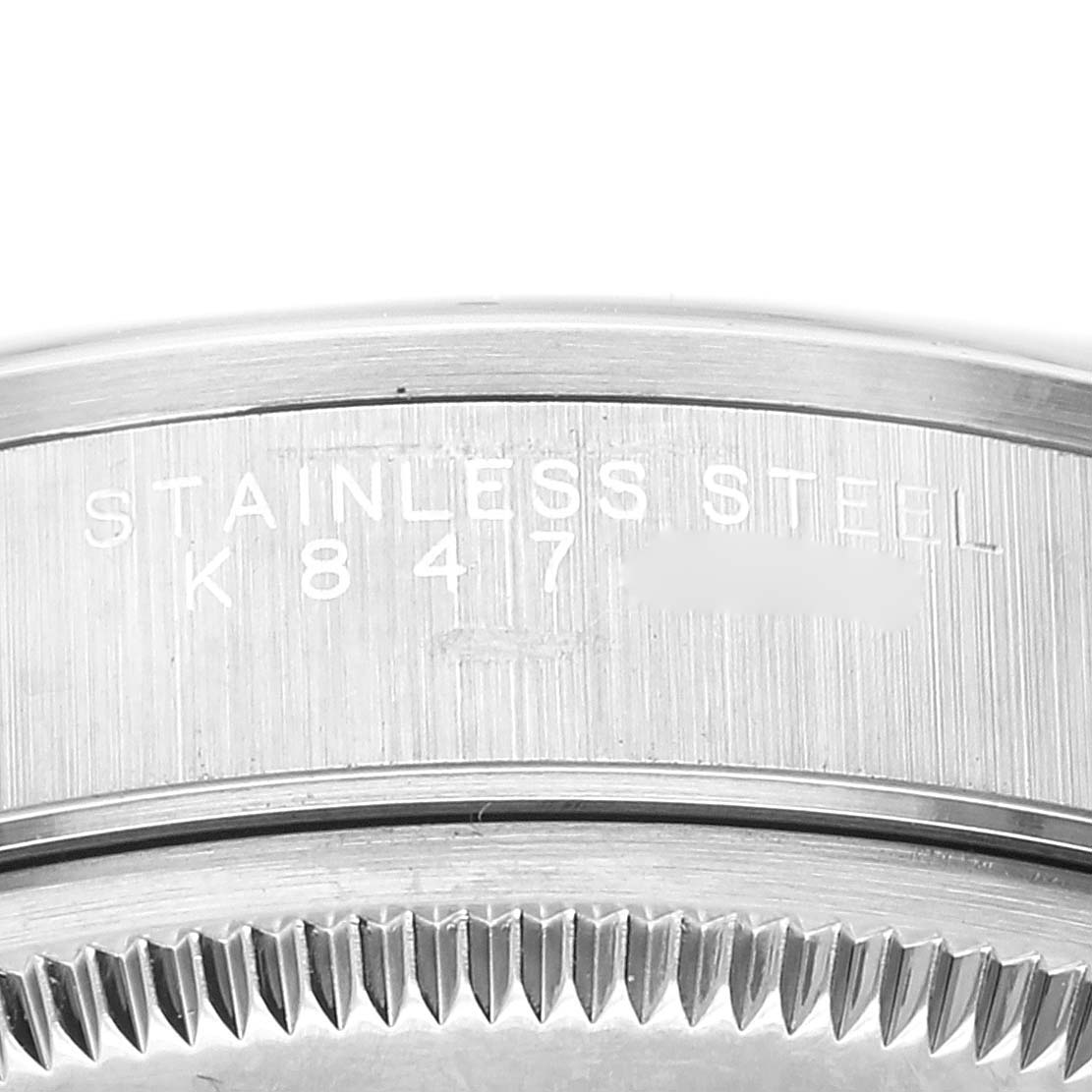 The image shows a close-up of the stainless steel case back and part of the bezel of a Rolex Air-King 14000 Men's Stainless Steel Blue Dial 14000 Men's Stainless Steel Blue Dial watch.