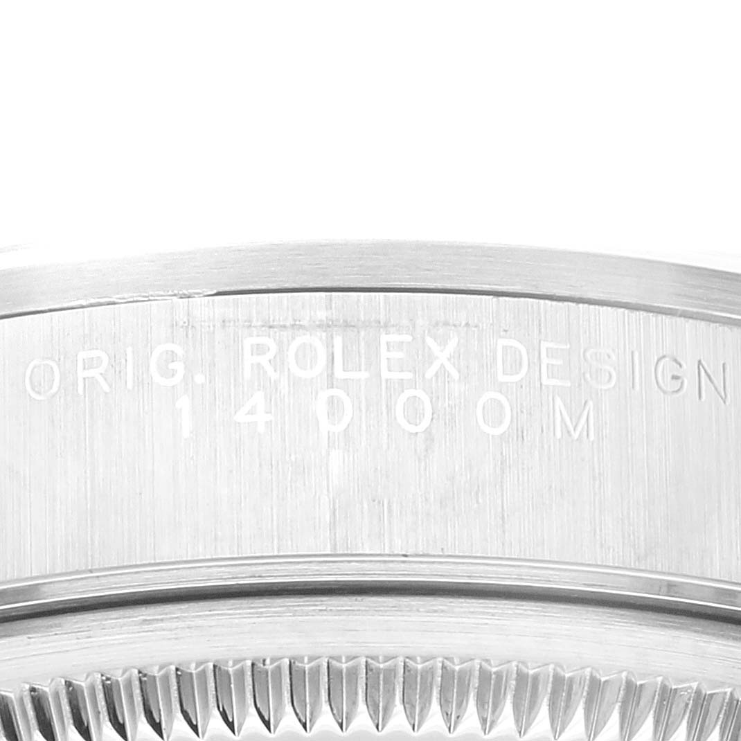 The close-up image of the Rolex Air-King 14000 Men's Stainless Steel Blue Dial 14000 Men's Stainless Steel Blue Dial watch shows the engraved bezel and part of the case back.