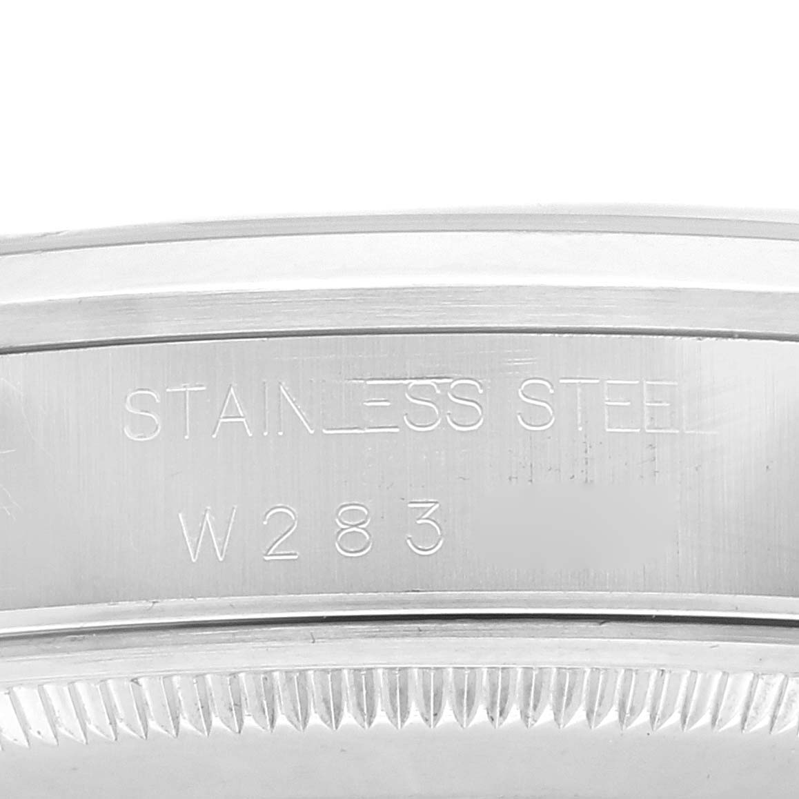 This image shows a close-up of the case back edge of a Rolex Air-King 14000 Men's Stainless Steel Blue Dial 14000 Men's Stainless Steel Blue Dial, highlighting the "STAINLESS STEEL" engraving and reference number.