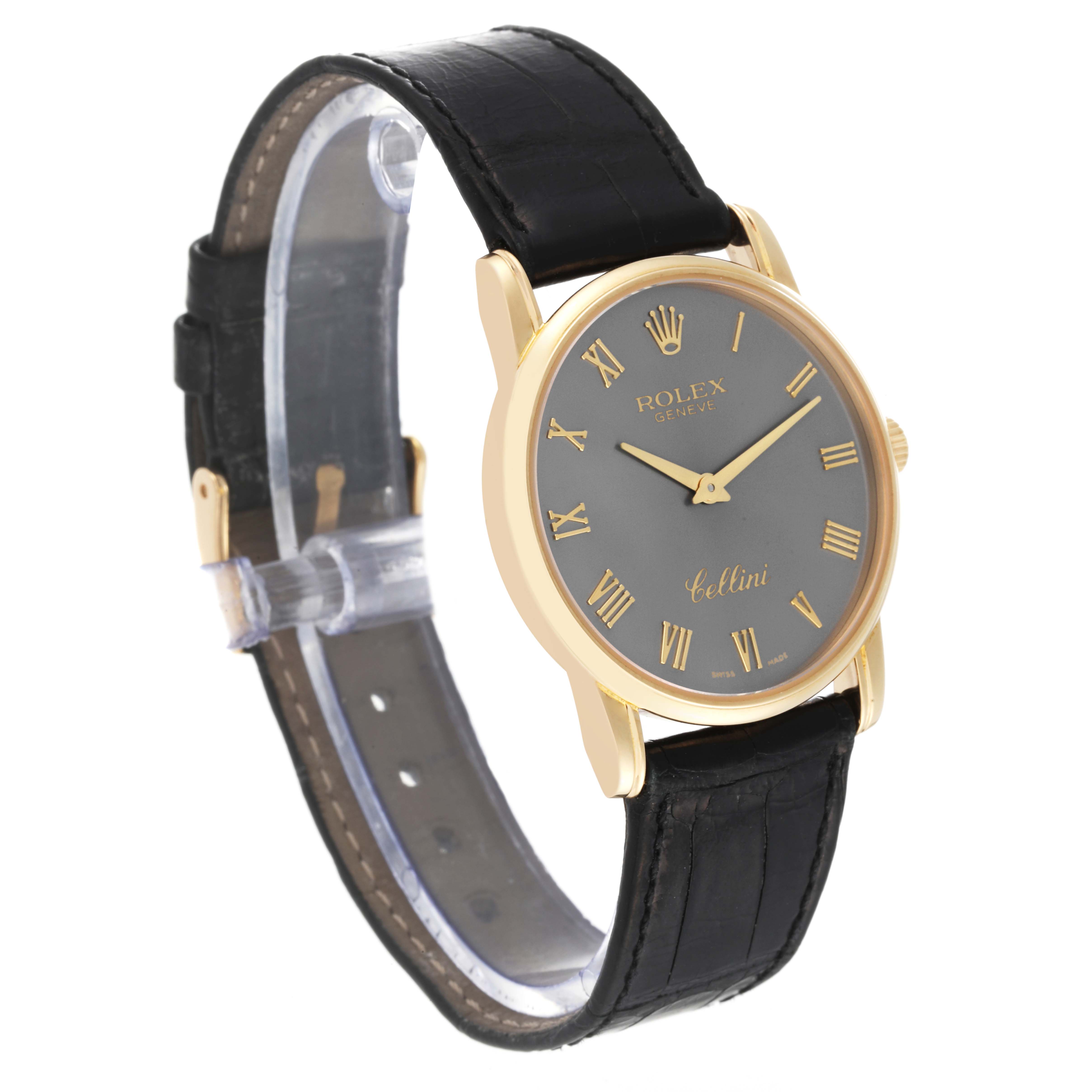 The Rolex Cellini 5116 Men's Yellow Gold Grey Dial 5116 Men's Yellow Gold Grey Dial watch is shown at a slight angle, displaying its face, black strap, and gold casing.