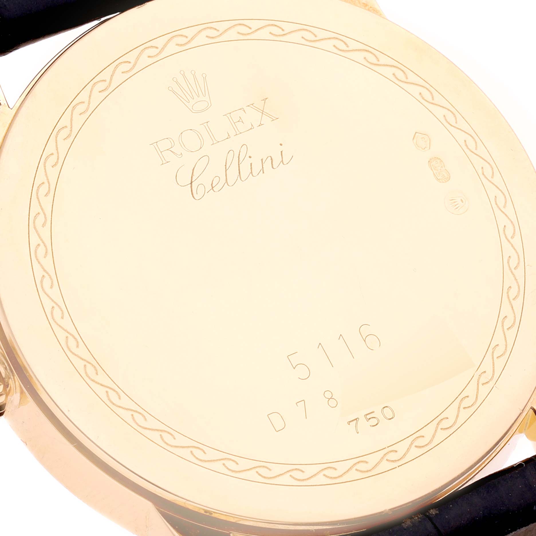 The image shows the engraved back case of a Rolex Cellini 5116 Men's Yellow Gold Grey Dial 5116 Men's Yellow Gold Grey Dial watch from a top angle.