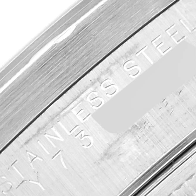 This is a close-up image of the inner rim of a Rolex Date 15210 Men's Stainless Steel Black Dial 15210 Men's Stainless Steel Black Dial model watch showing the engraved "STAINLESS STEEL".