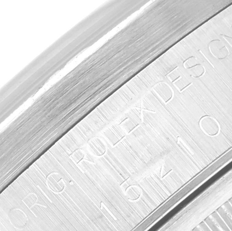 This image shows an angled view of the serialized case side with engravings on a Rolex Date 15210 Men's Stainless Steel Blue Dial 15210 Men's Stainless Steel Blue Dial model watch.