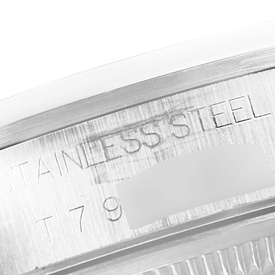 This close-up image shows the engraved "STAINLESS STEEL" text on the side of a Rolex Date 15200 Men's Stainless Steel Blue Dial 15200 Men's Stainless Steel Blue Dial model watch's case.