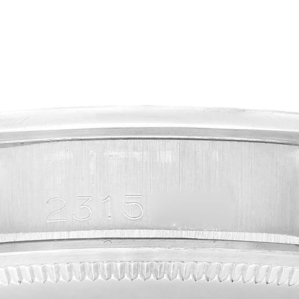The image shows a close-up of the case side of the Rolex Date 1500 Men
s Stainless Steel Silver Dial 1500 Men
s Stainless Steel Silver Dial model watch, with a partial view of the serial number engraving.