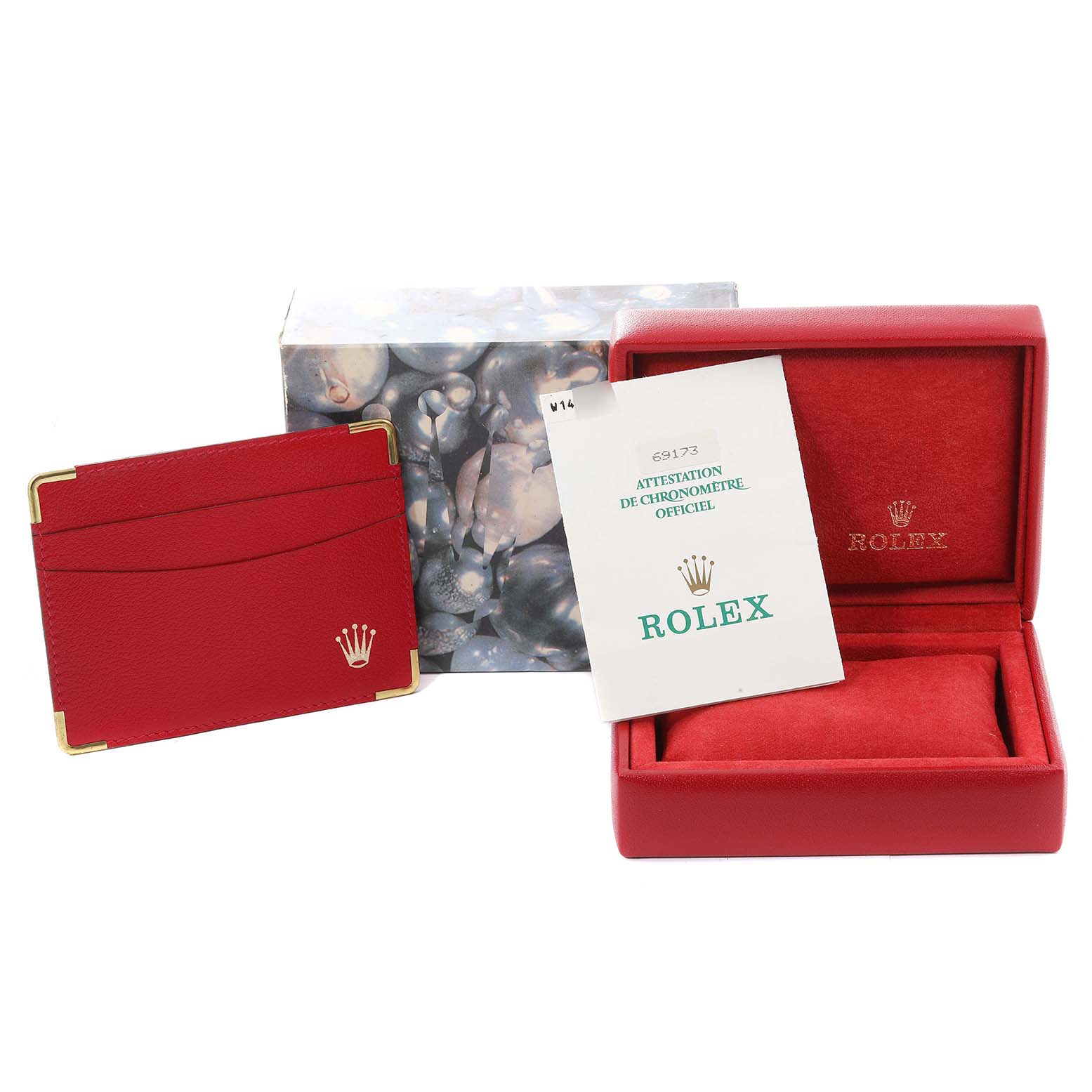 The image shows a Rolex Datejust 69173 Women's Steel and Gold (two tone) Silver Dial 69173 Women's Steel and Gold (two tone) Silver Dial box set with a red case, warranty card, and a booklet viewed from the front.