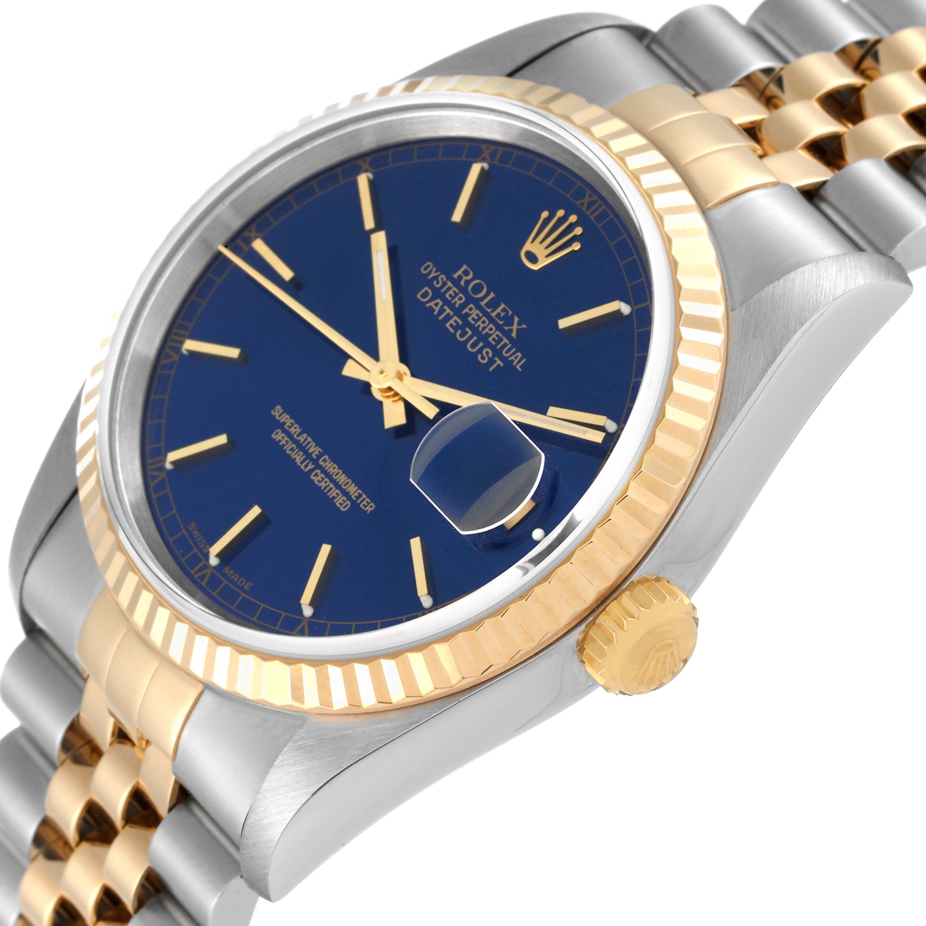 This image shows a close-up, angled view of a Rolex Datejust 16233 Men's Steel and Gold (two tone) Blue Dial 16233 Men's Steel and Gold (two tone) Blue Dial watch, highlighting its blue dial, gold fluted bezel, and two-tone bracelet.