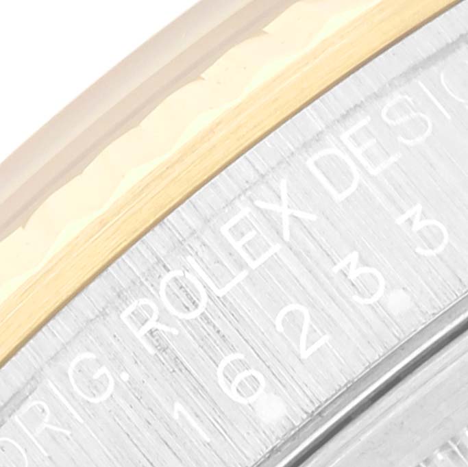 Close-up of the Rolex Datejust 16233 Men's Steel and Gold (two tone) Blue Dial 16233 Men's Steel and Gold (two tone) Blue Dial watch bezel showing part of the engravings and the two-tone design.