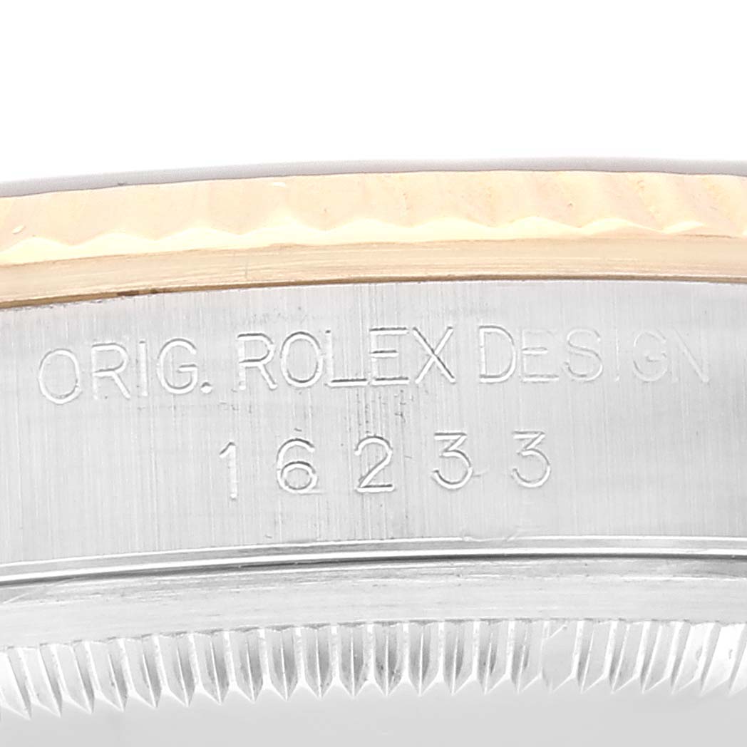 The image shows the side view of the Rolex Datejust 16233 Men's Steel and Gold (two tone) Blue Dial 16233 Men's Steel and Gold (two tone) Blue Dial model, focusing on the engraved serial and design numbers.