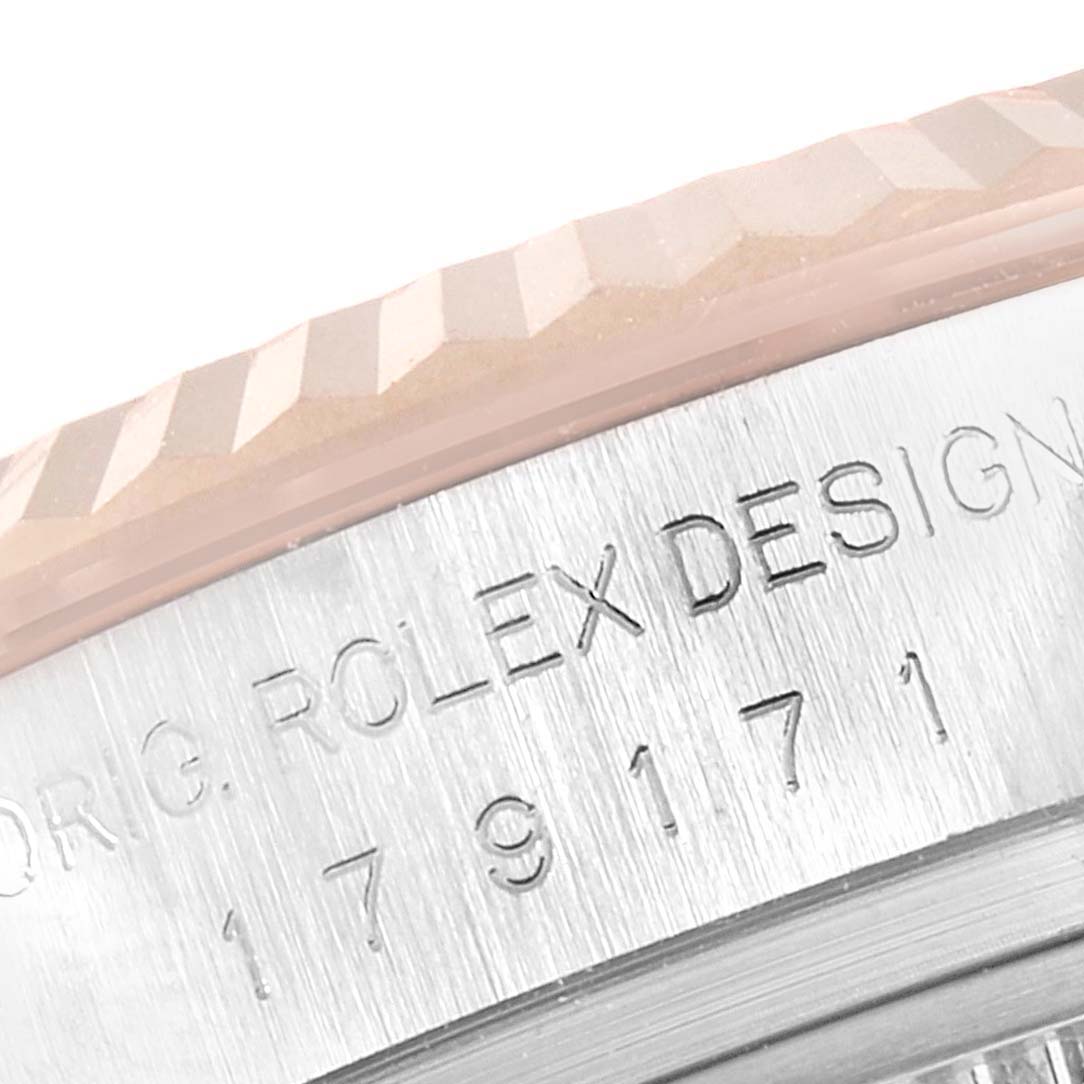 This close-up angle shows the engraved casing and part of the fluted bezel of a Rolex Datejust 179171 Women's Steel and Gold (two tone) Pink Dial 179171 Women's Steel and Gold (two tone) Pink Dial watch.