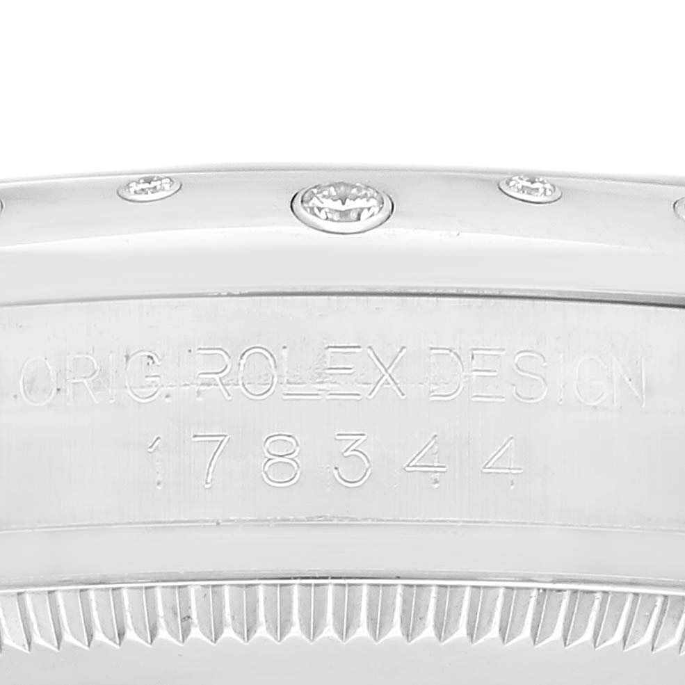 The image shows a close-up of the bezel and engraved model number on a Mid-Size Rolex watch.