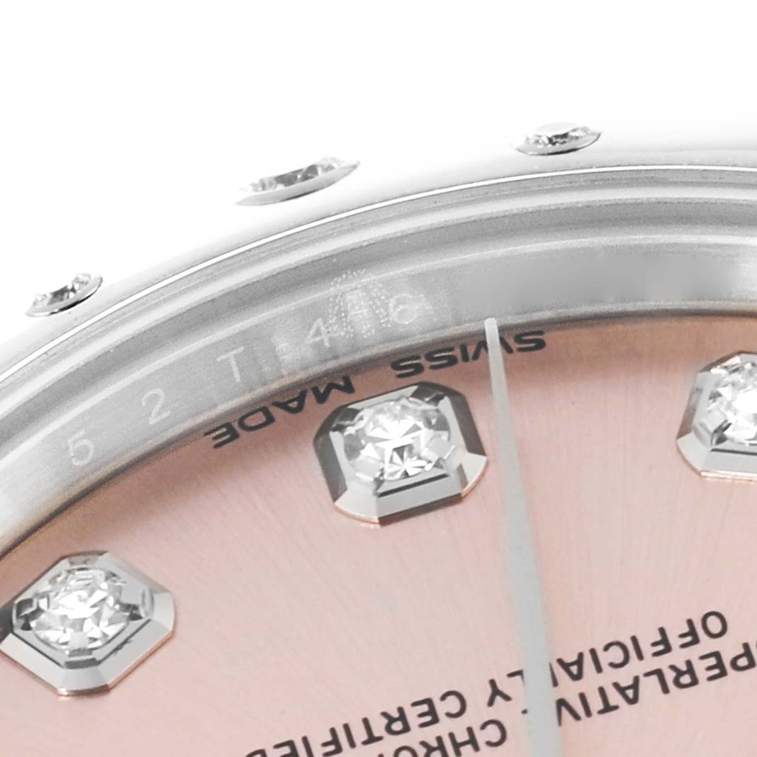 This close-up image of a Rolex Mid-Size 178344 Women's Stainless Steel Pink Dial 178344 Women's Stainless Steel Pink Dial watch shows part of the dial and bezel with diamond hour markers and "Swiss Made" text.