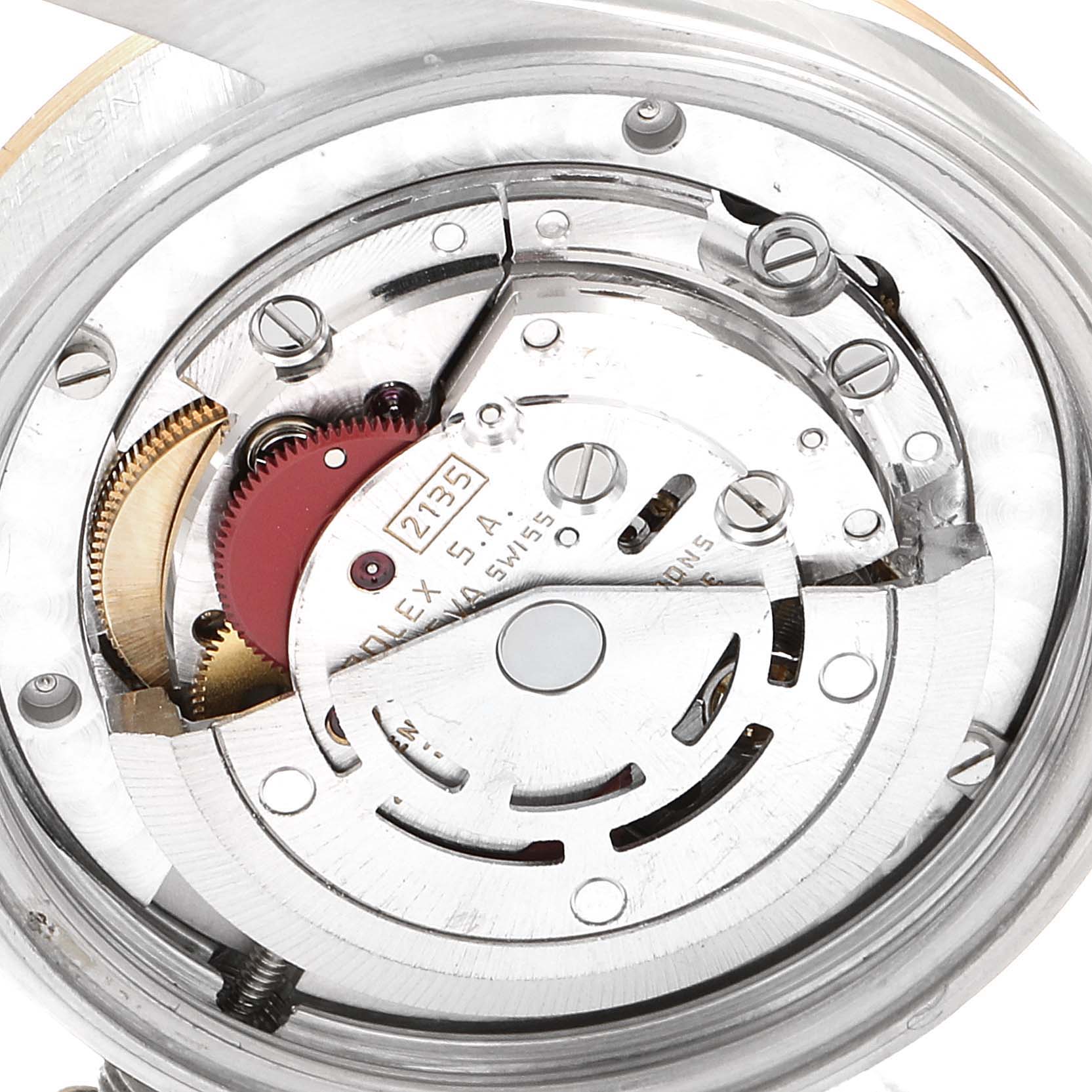 This image shows a close-up of the internal mechanism of a Rolex Mid-Size 68273 Women's Steel and Gold (two tone) Champagne Dial 68273 Women's Steel and Gold (two tone) Champagne Dial watch, focusing on the components and gears.