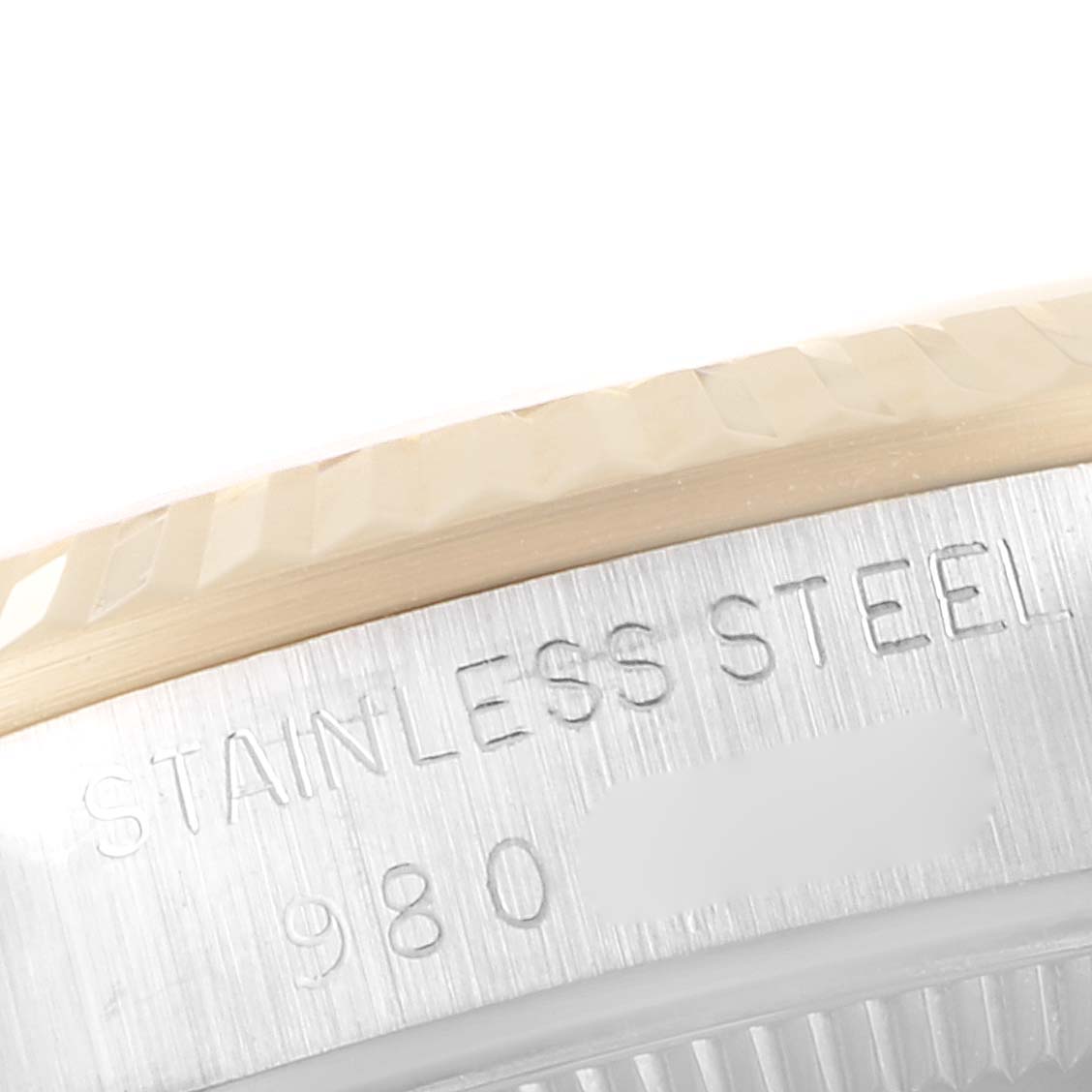 This image shows a close-up of the bezel and case side of a mid-size Rolex watch, highlighting its stainless steel material.