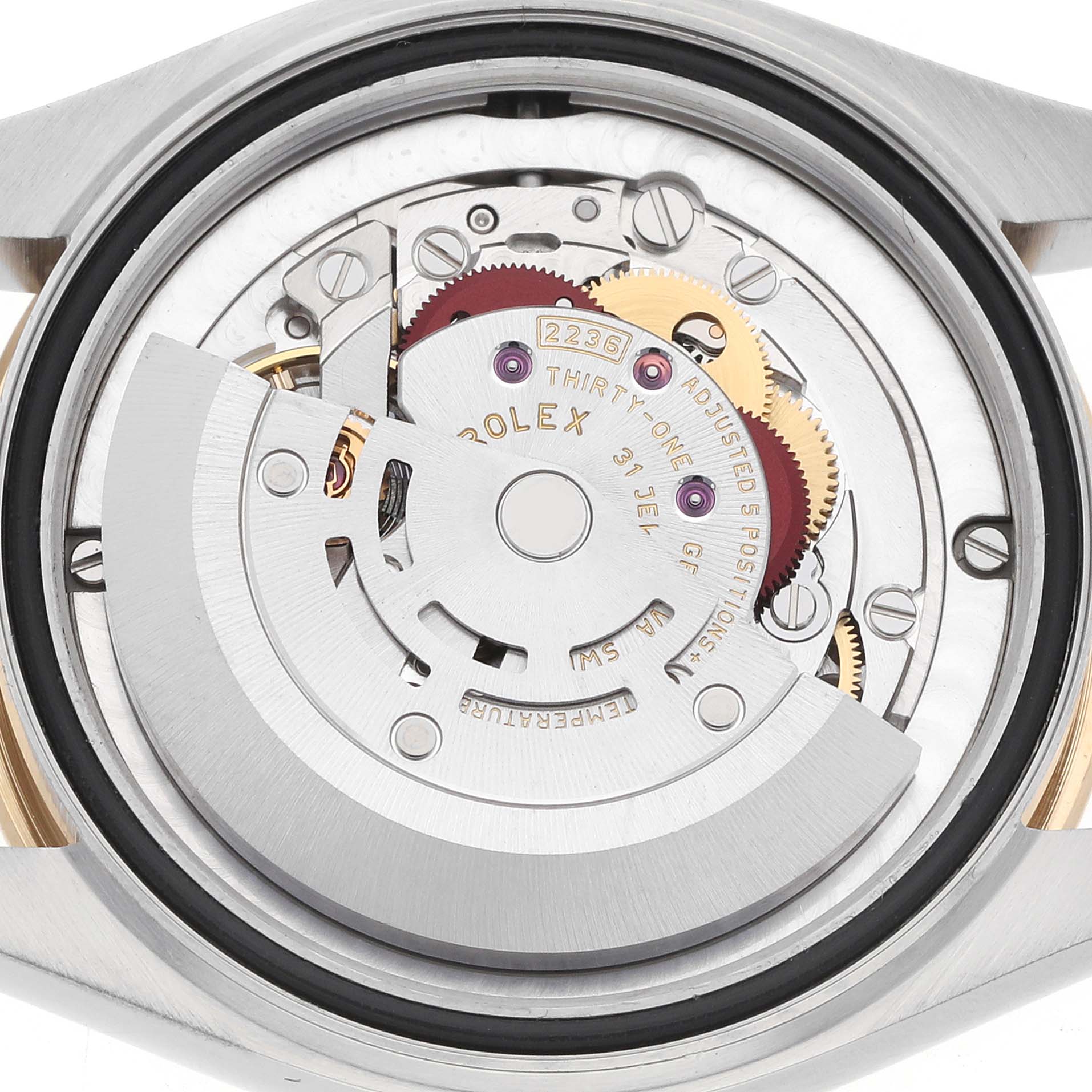 The image shows the movement of a Rolex Datejust 278273 Women
s Steel and Gold (two tone) White Dial, viewed from the back, highlighting gears and the rotor.