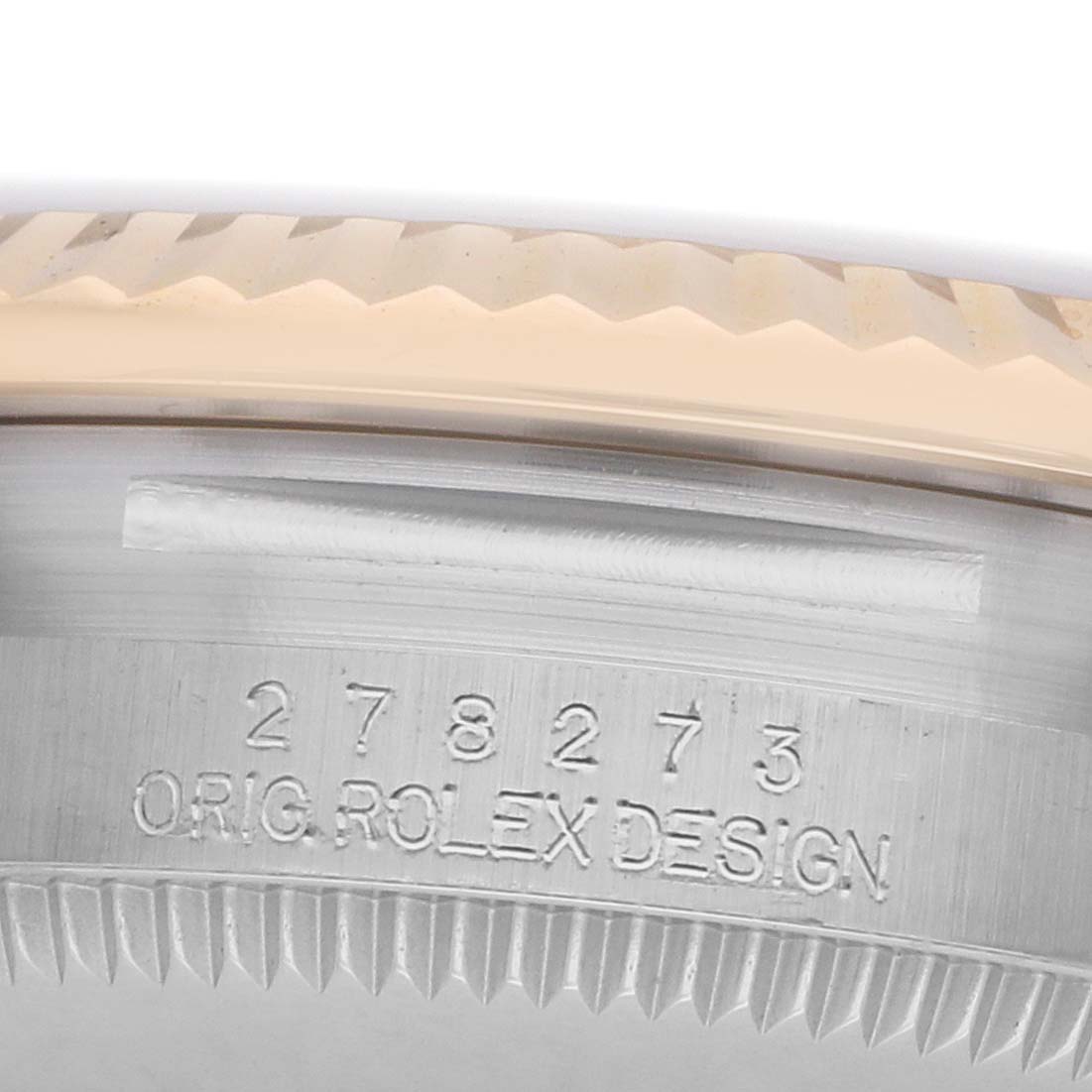 The image shows a close-up of the inner bezel, detailing the serial number and "ORIG. ROLEX DESIGN" engraving of a Rolex Datejust 278273 Women
s Steel and Gold (two tone) White Dial.