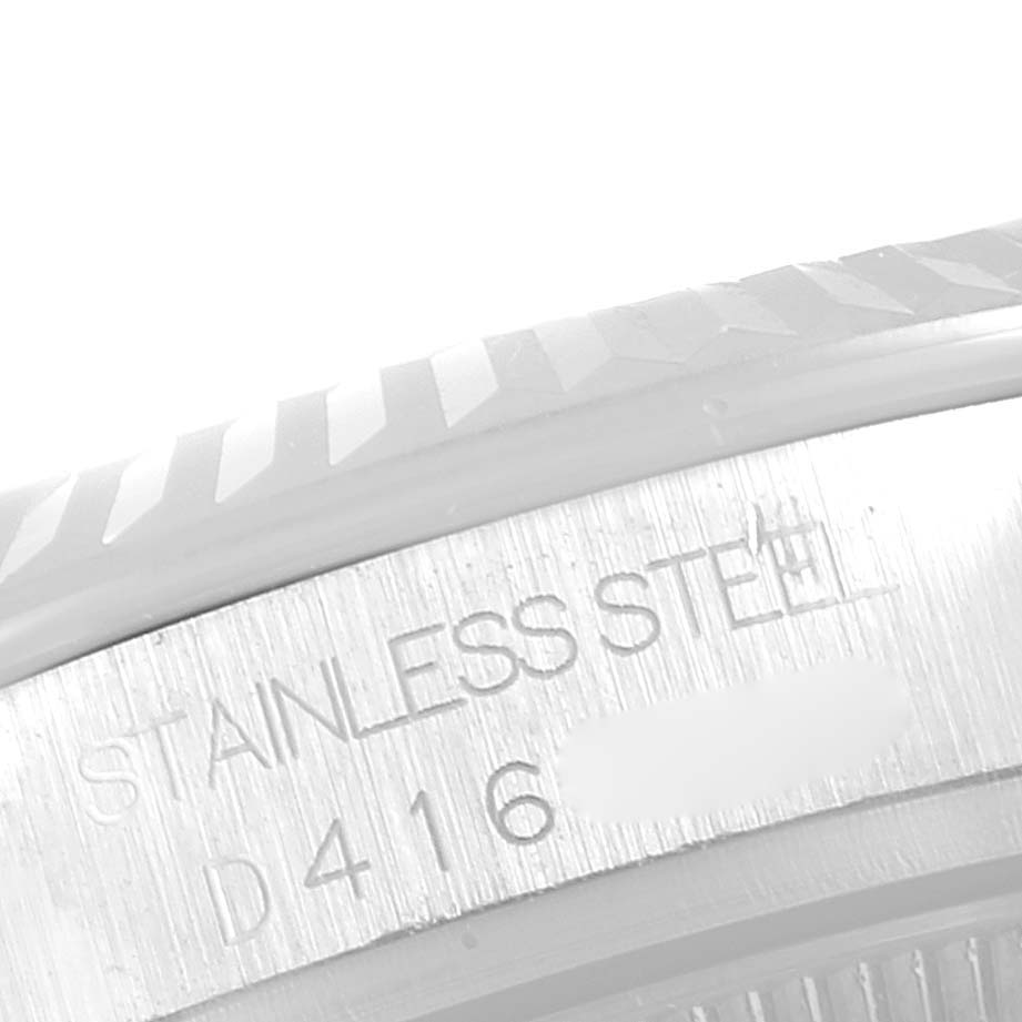 The image shows a close-up of the side of a Mid-Size Rolex watch with "STAINLESS STEEL" and a partial serial number engraved.
