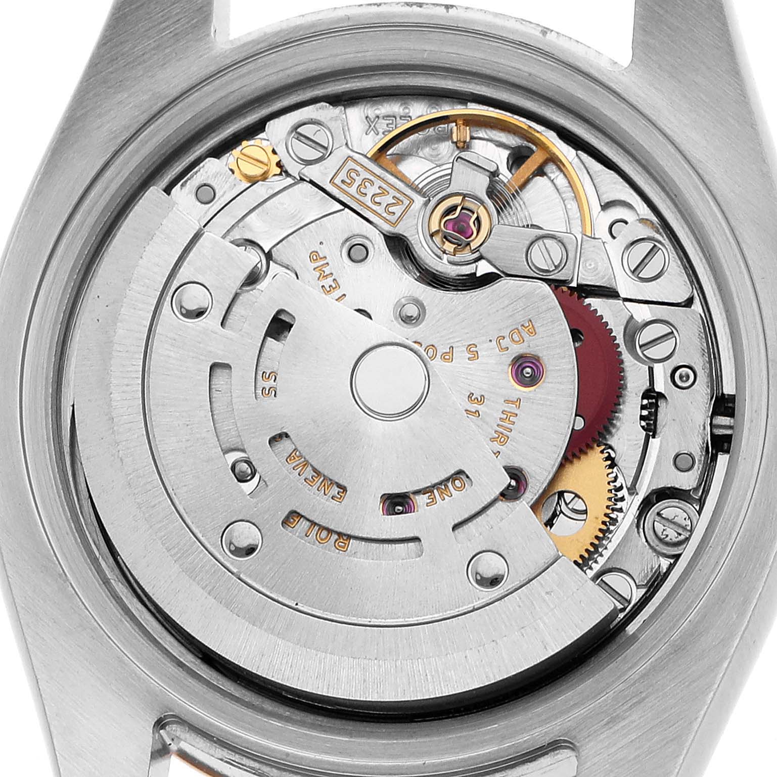 The image shows the inner mechanical movement of a Rolex Datejust 179171 Women's Steel and Gold (two tone) Silver Dial watch from a back view, highlighting gears and components.