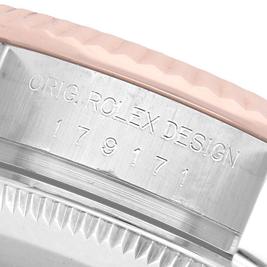 The image shows a close-up of the Rolex Datejust 179171 Women's Steel and Gold (two tone) Silver Dial's engraved side, focusing on the bezel and case edge.