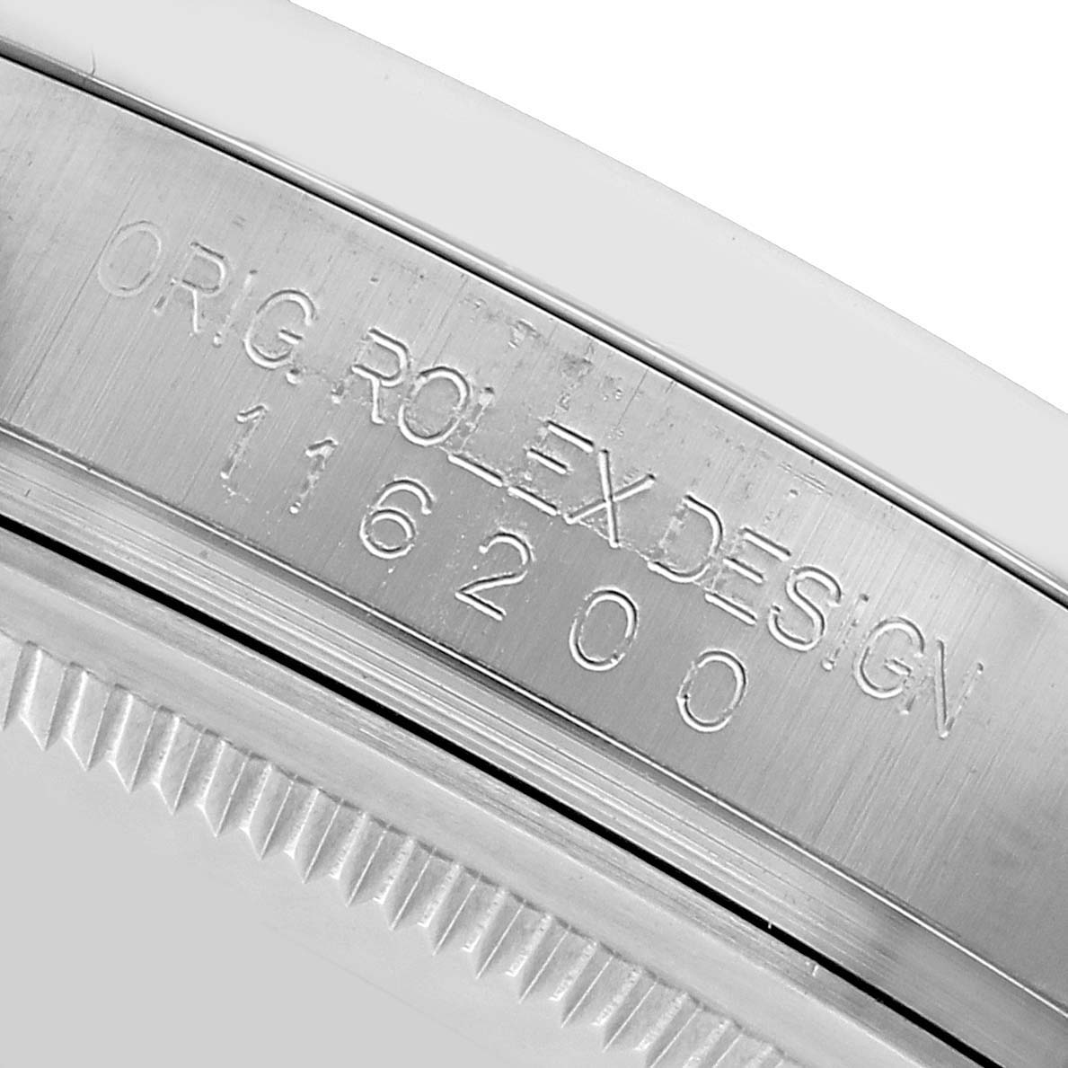 The image shows a close-up of the side engraving on a Rolex Datejust 116200 Men
s Stainless Steel White Dial watch case, highlighting model details.