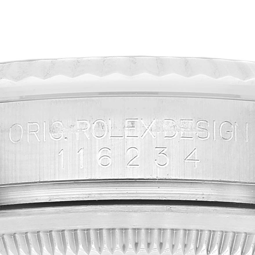 This is a close-up of the Rolex Datejust 116234 Men's Stainless Steel Black Dial 116234 Men's Stainless Steel Black Dial model, showing the side of the case with engraved model numbers and text.